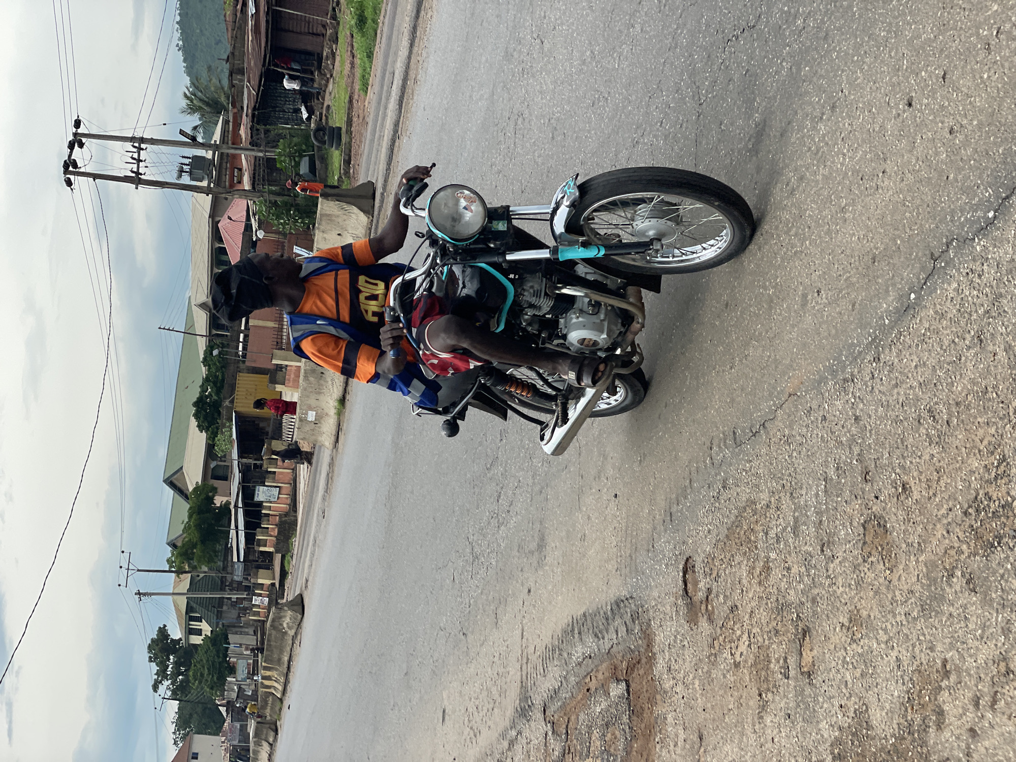 Morning street life along a wet road in Lokoja, Nigeria