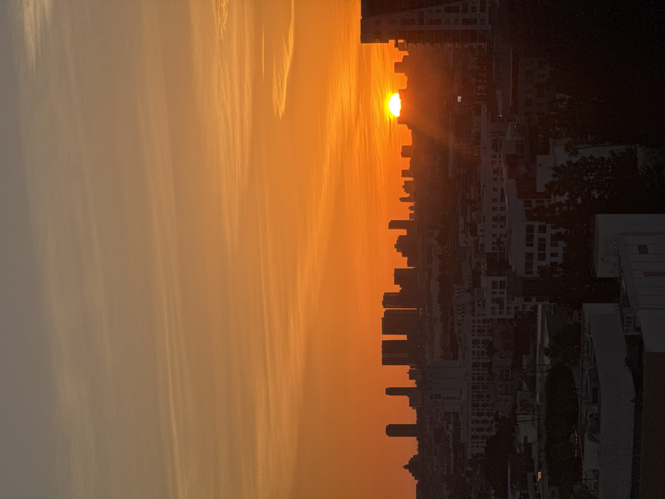 Orange sunset illuminates Los Angeles skyline with dramatic shadows