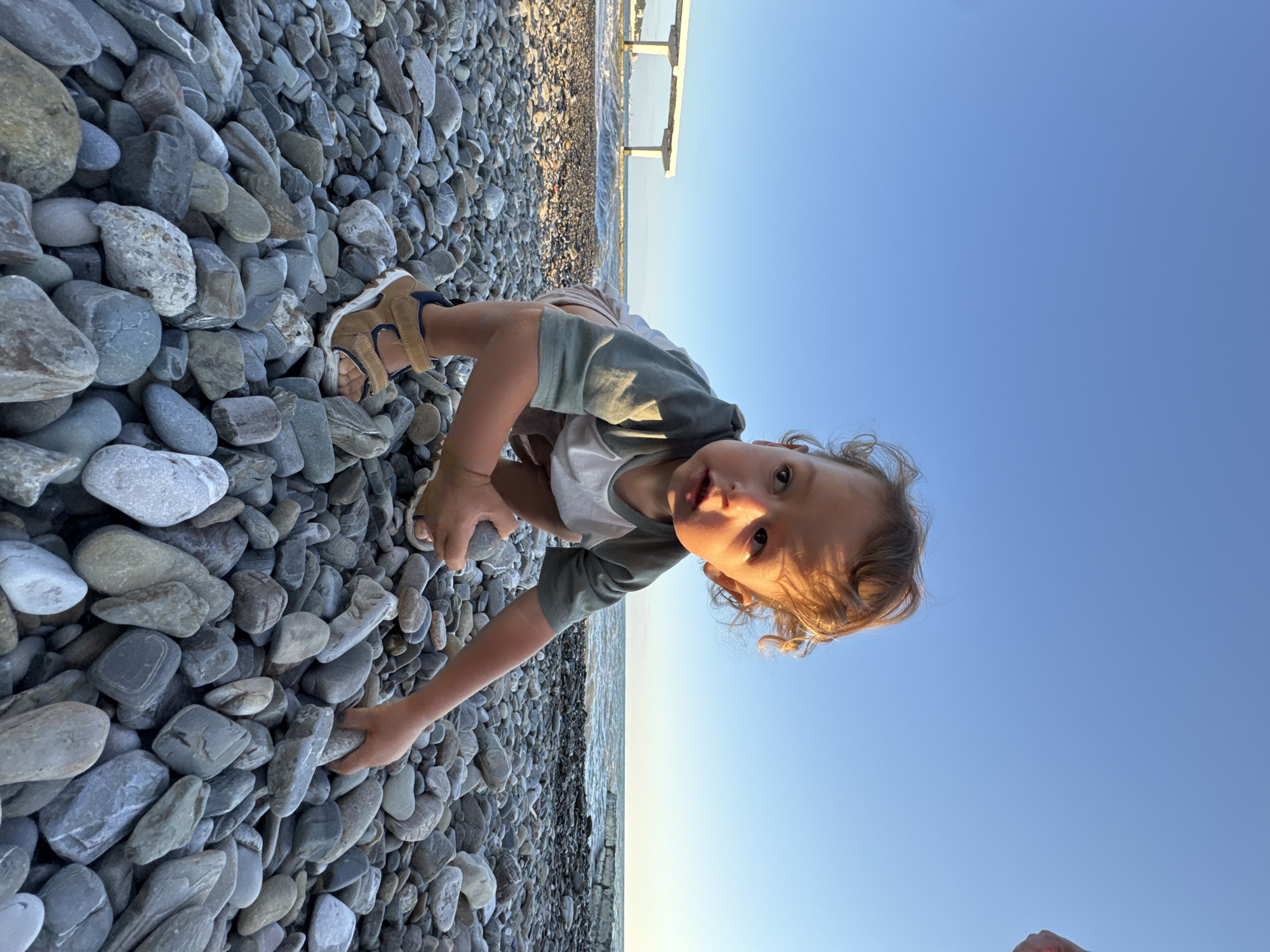 Golden hour on a Sochi pebble beach, summer evening