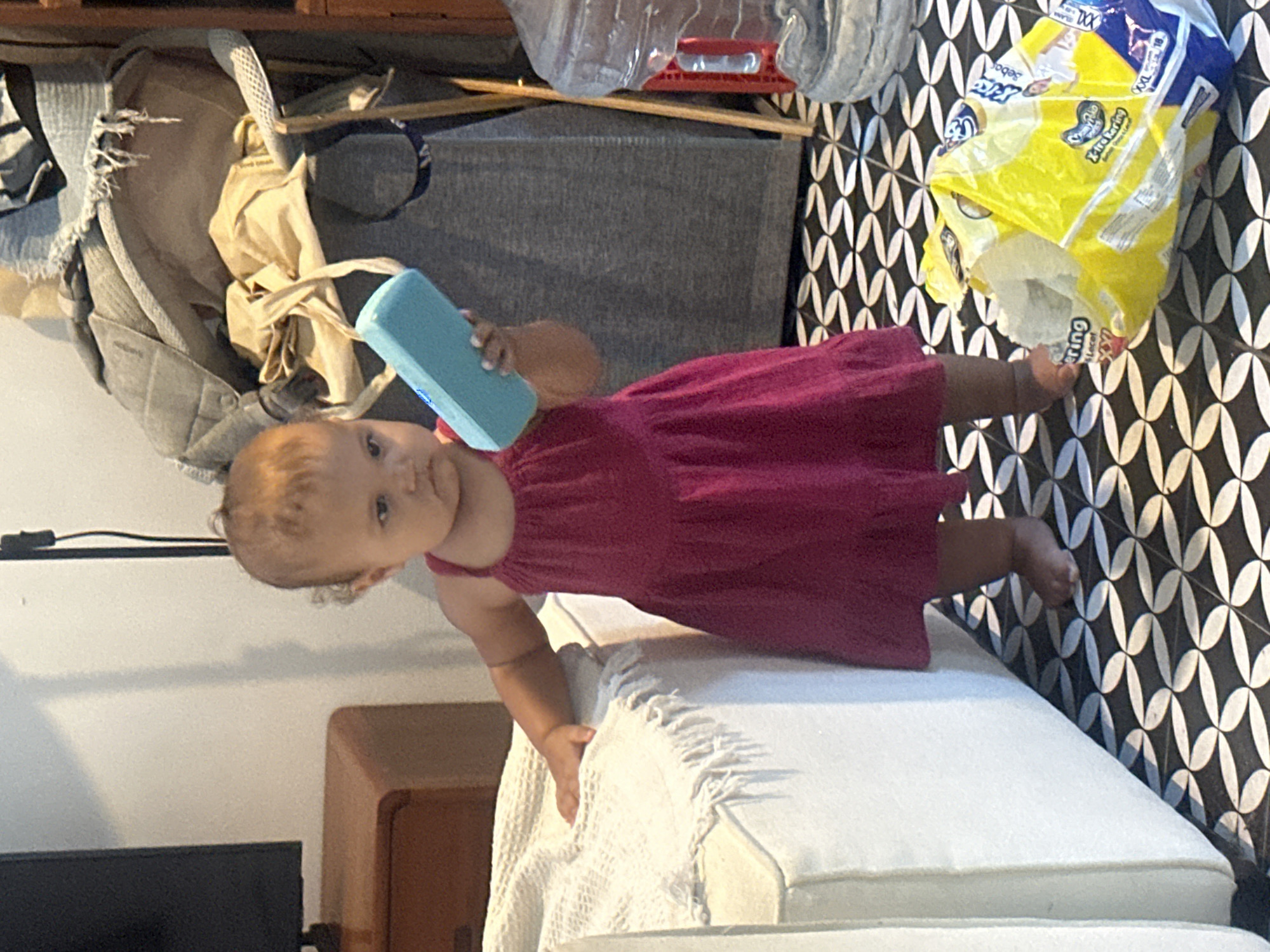 Pink dress, patterned tiles, and a blue object in North Kuta