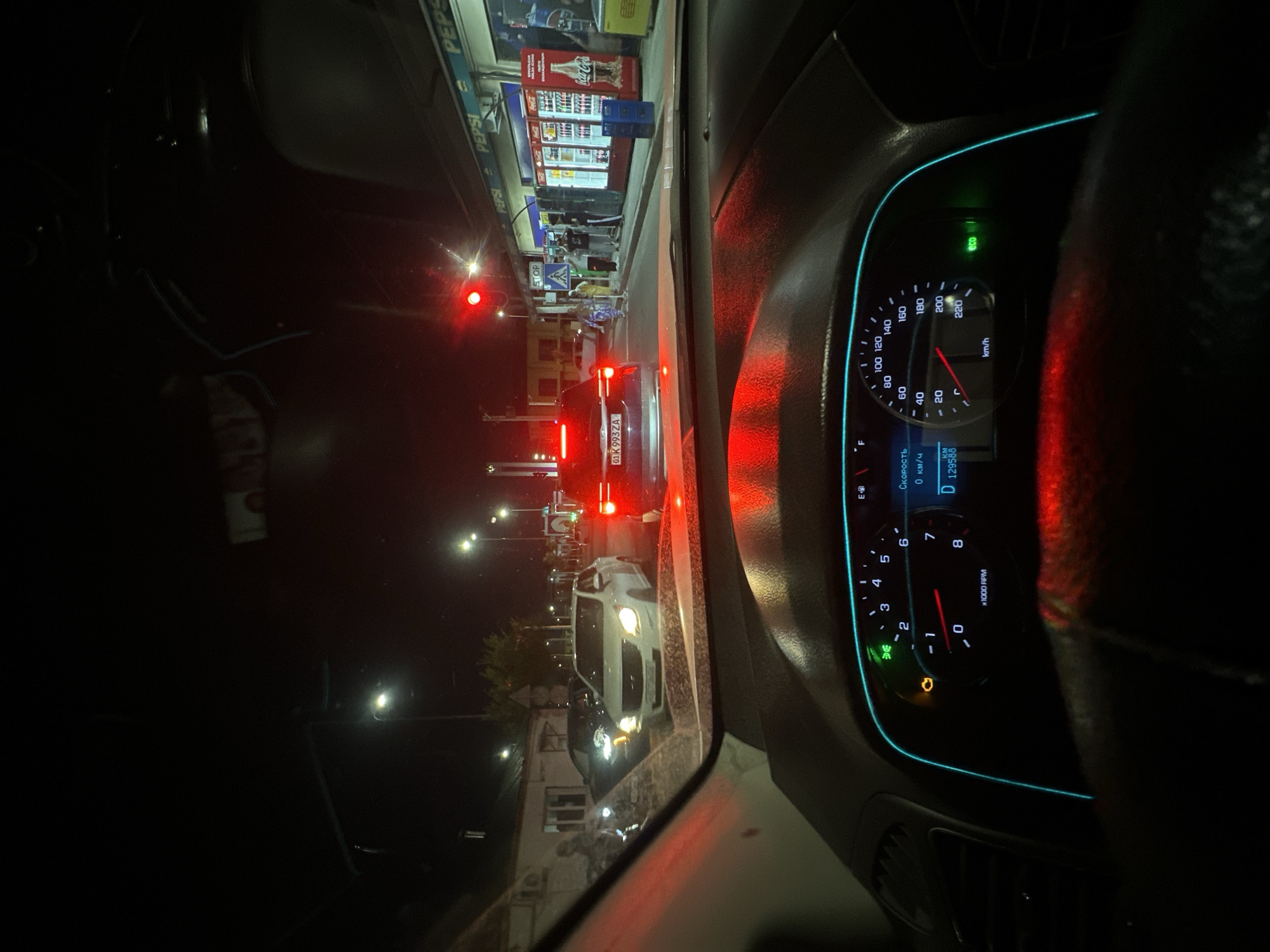 Tashkent night traffic, stopped at a red light near shops