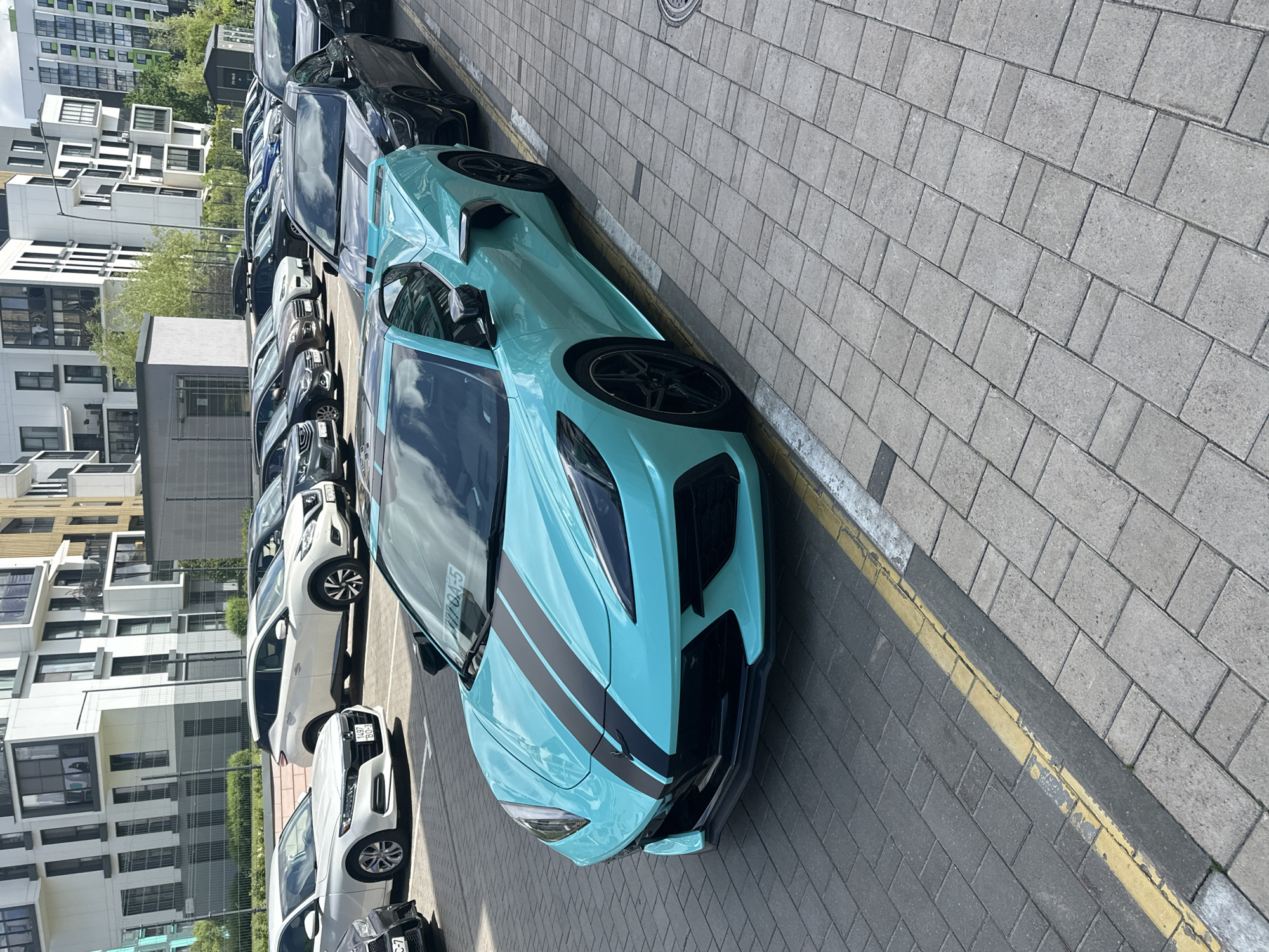 Everyday moments captured in Belarus suburb feature sports car, buildings