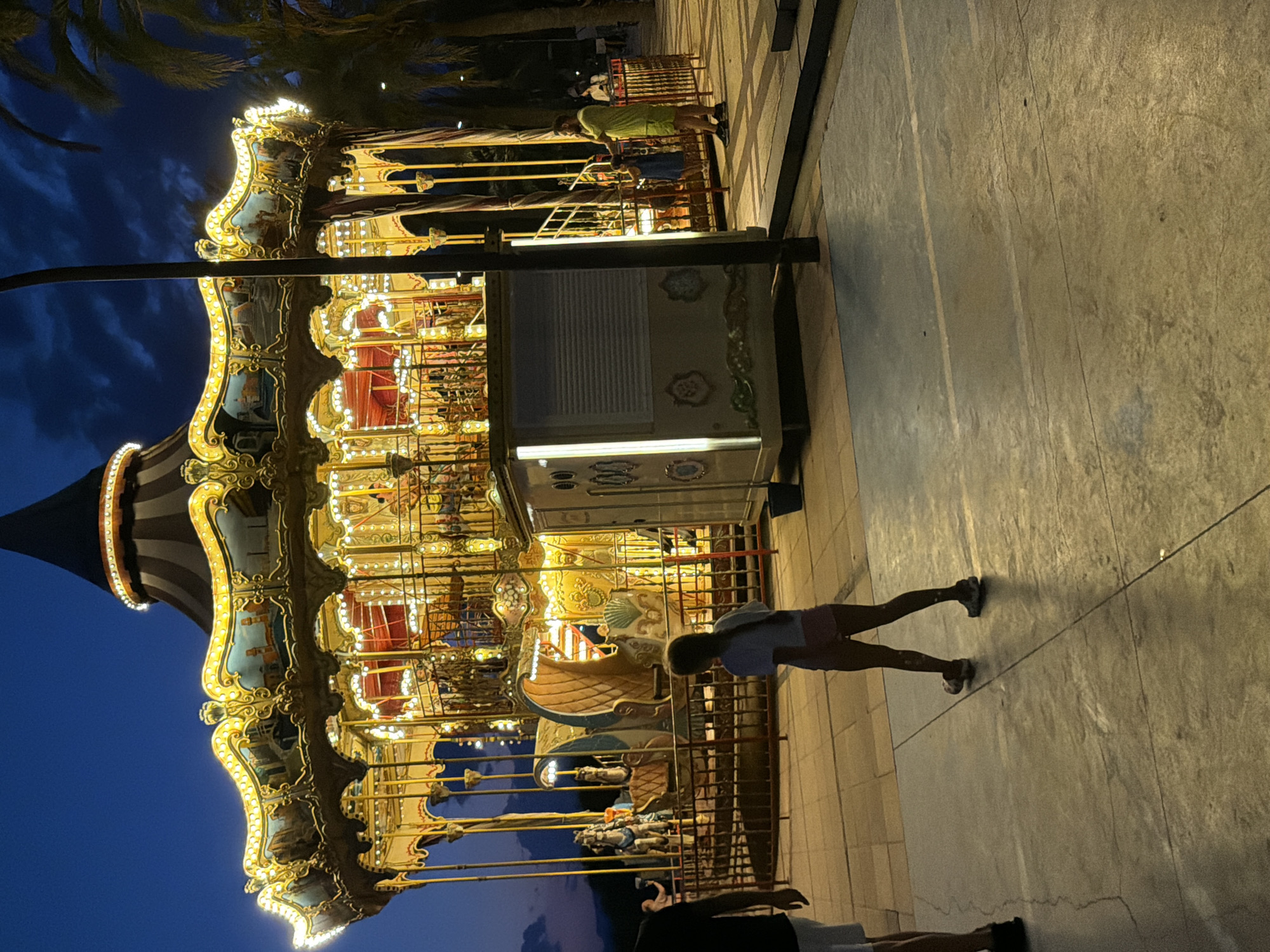 Illuminated carousel glows at twilight in Cambrils, Spain