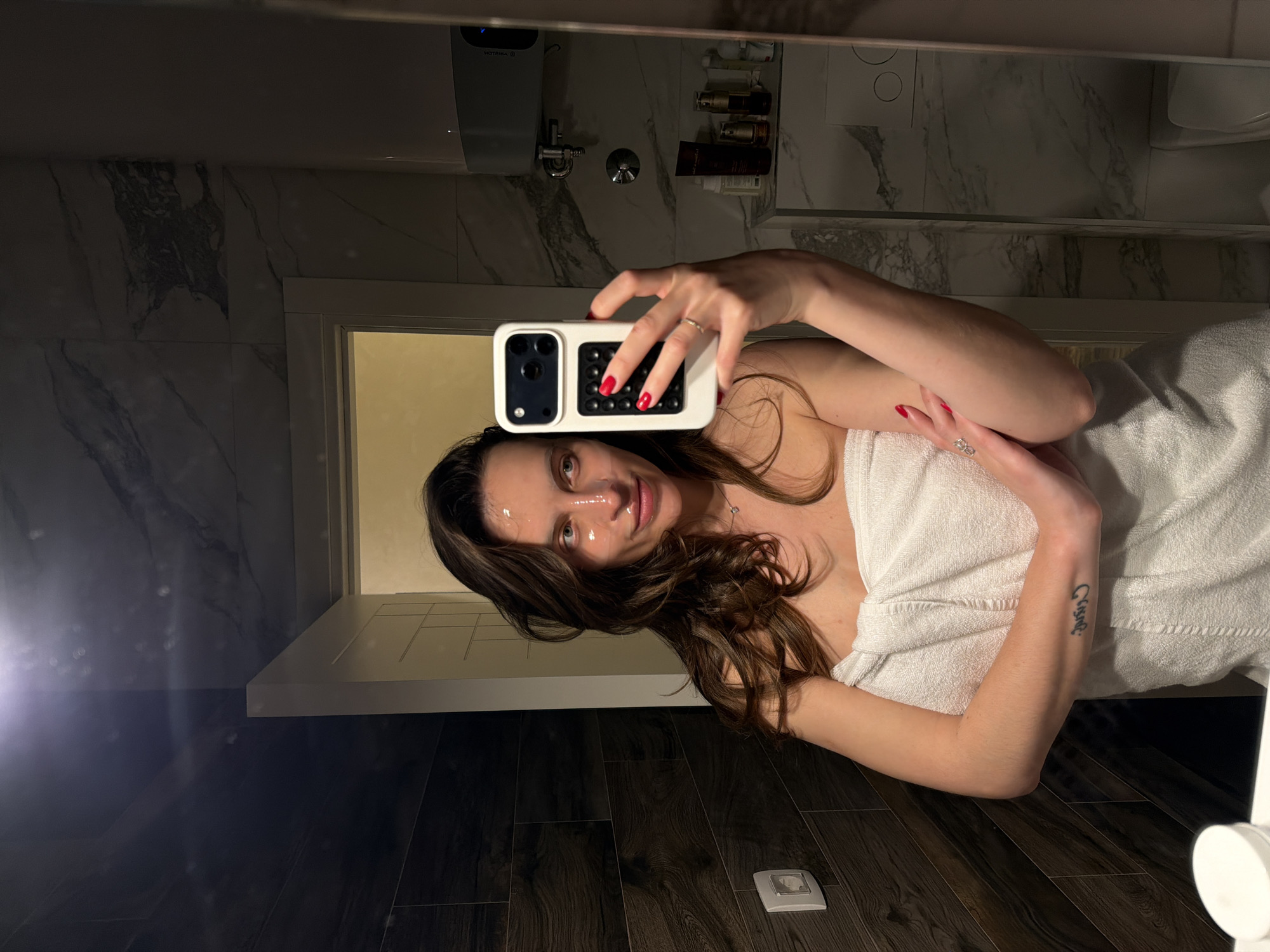 Woman takes bathroom selfies during skincare routine in Budva