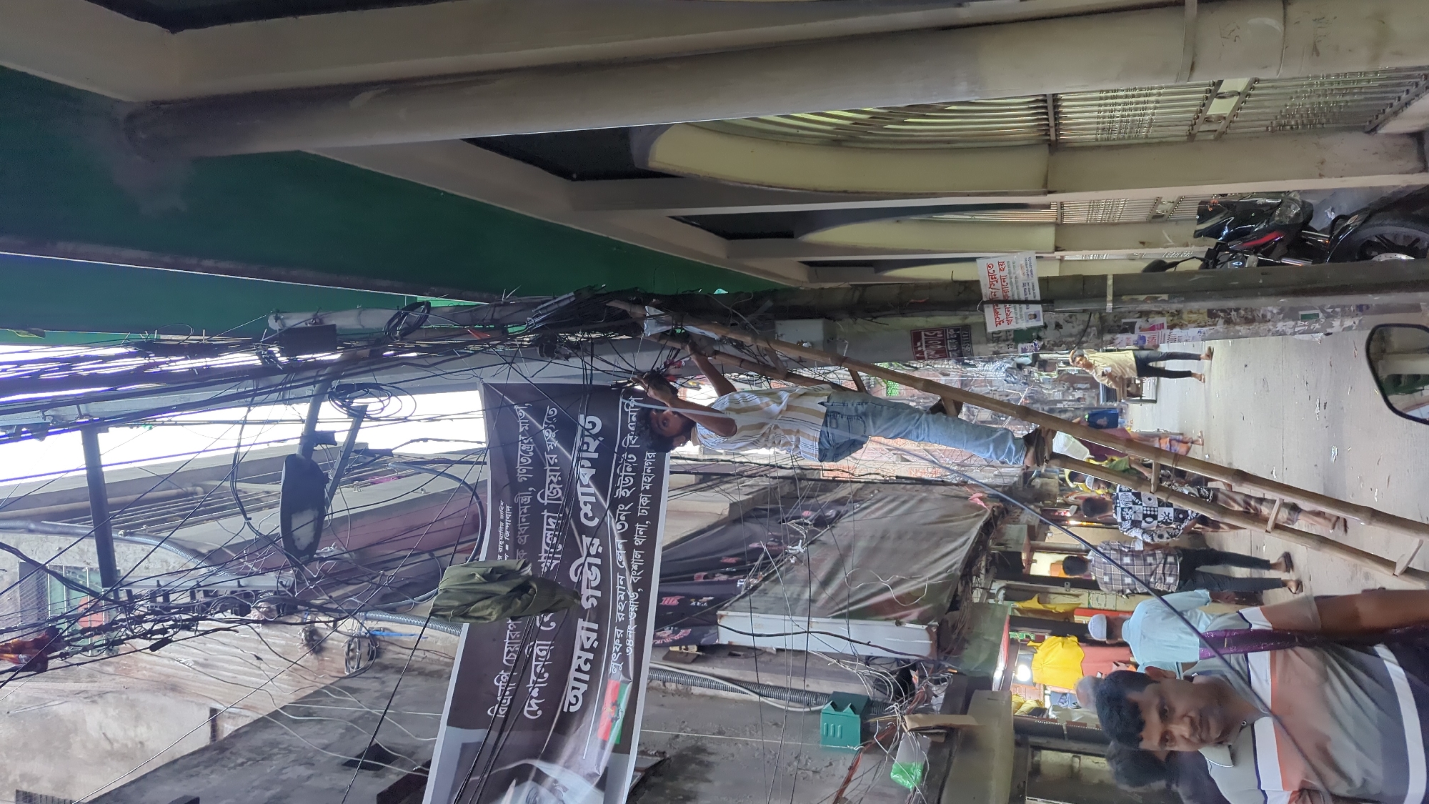 Electrical repair work on busy Dhaka street