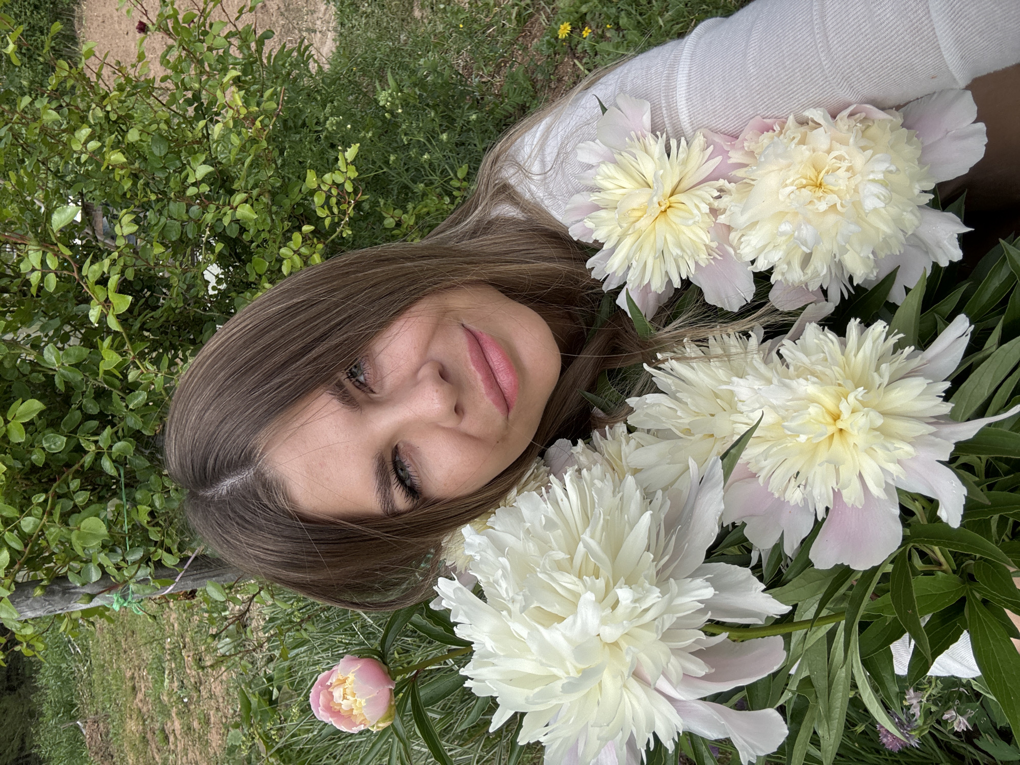 Woman photographs peonies, cat catches mouse in Фоки, Russia