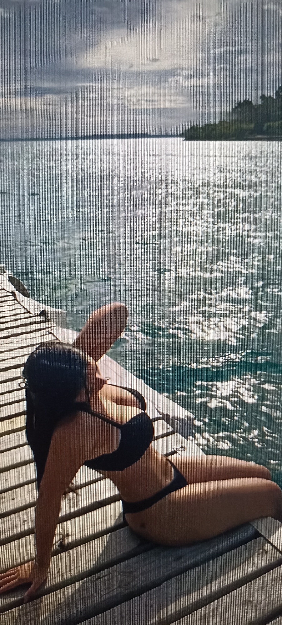 Relaxing by the water's edge in a black bikini