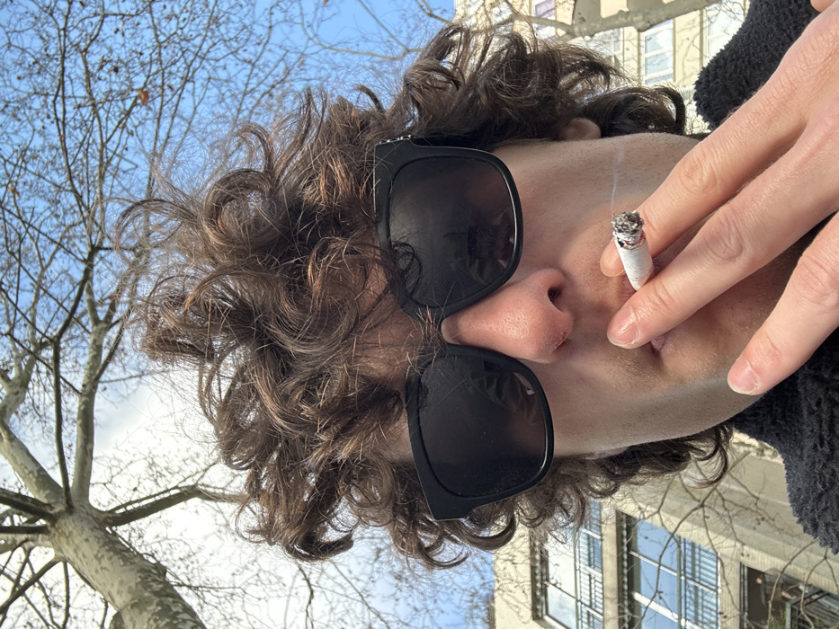 Person takes selfies on Paris street Monday morning
