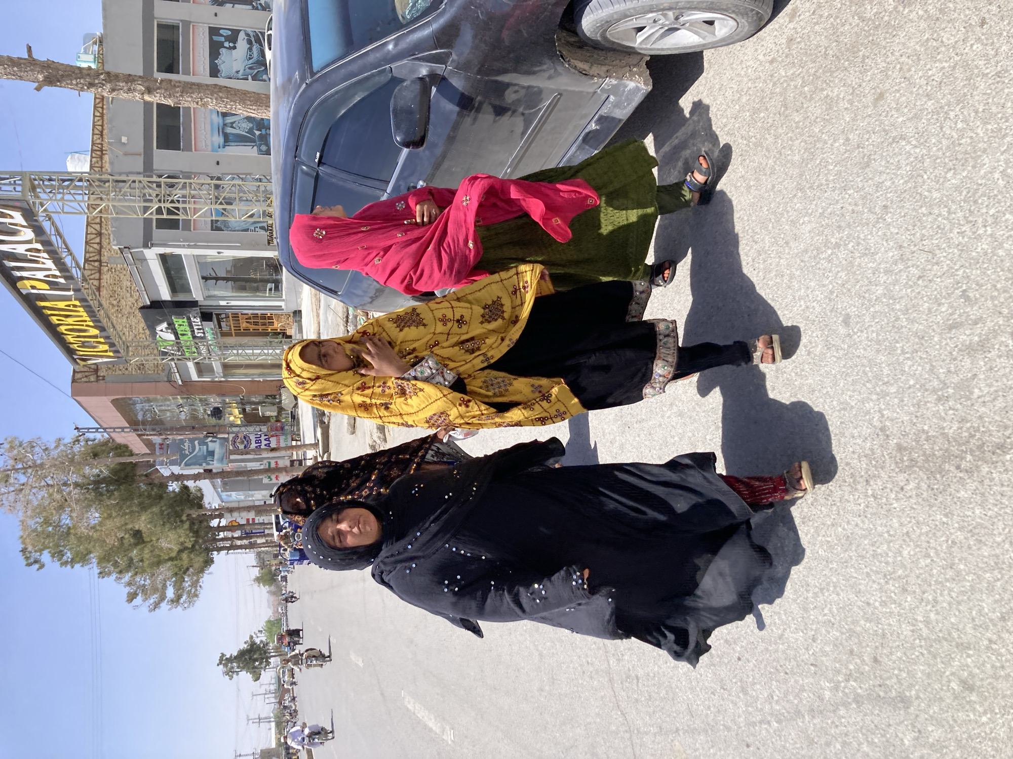 Three women gather on sunny Quetta street