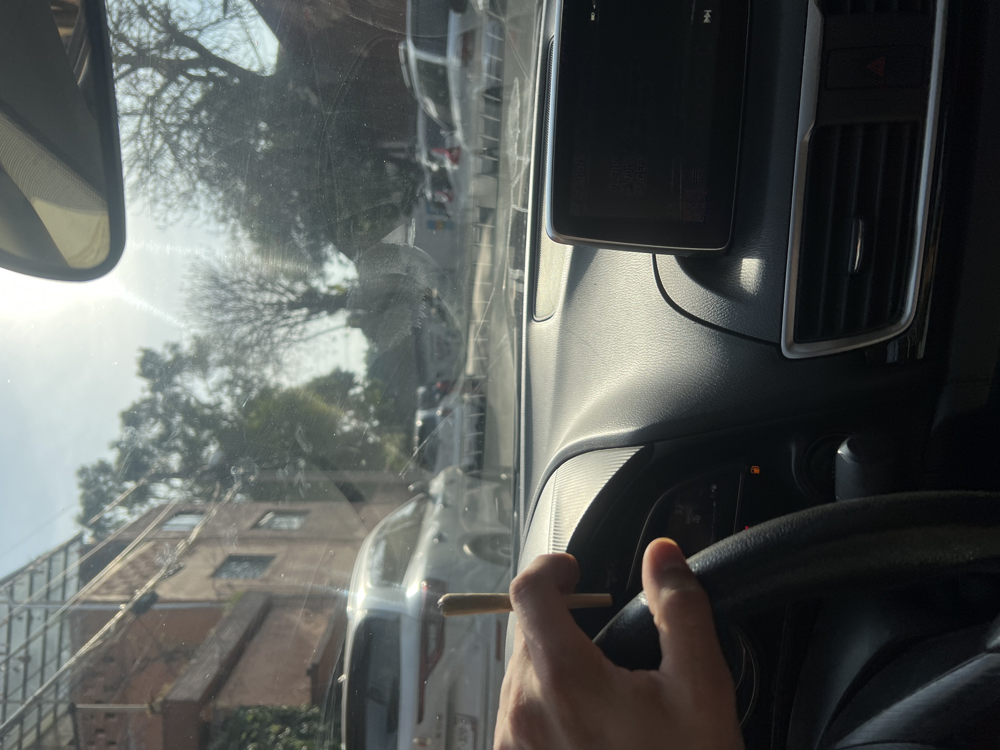 Driver holds cigarette while driving in Mexico City
