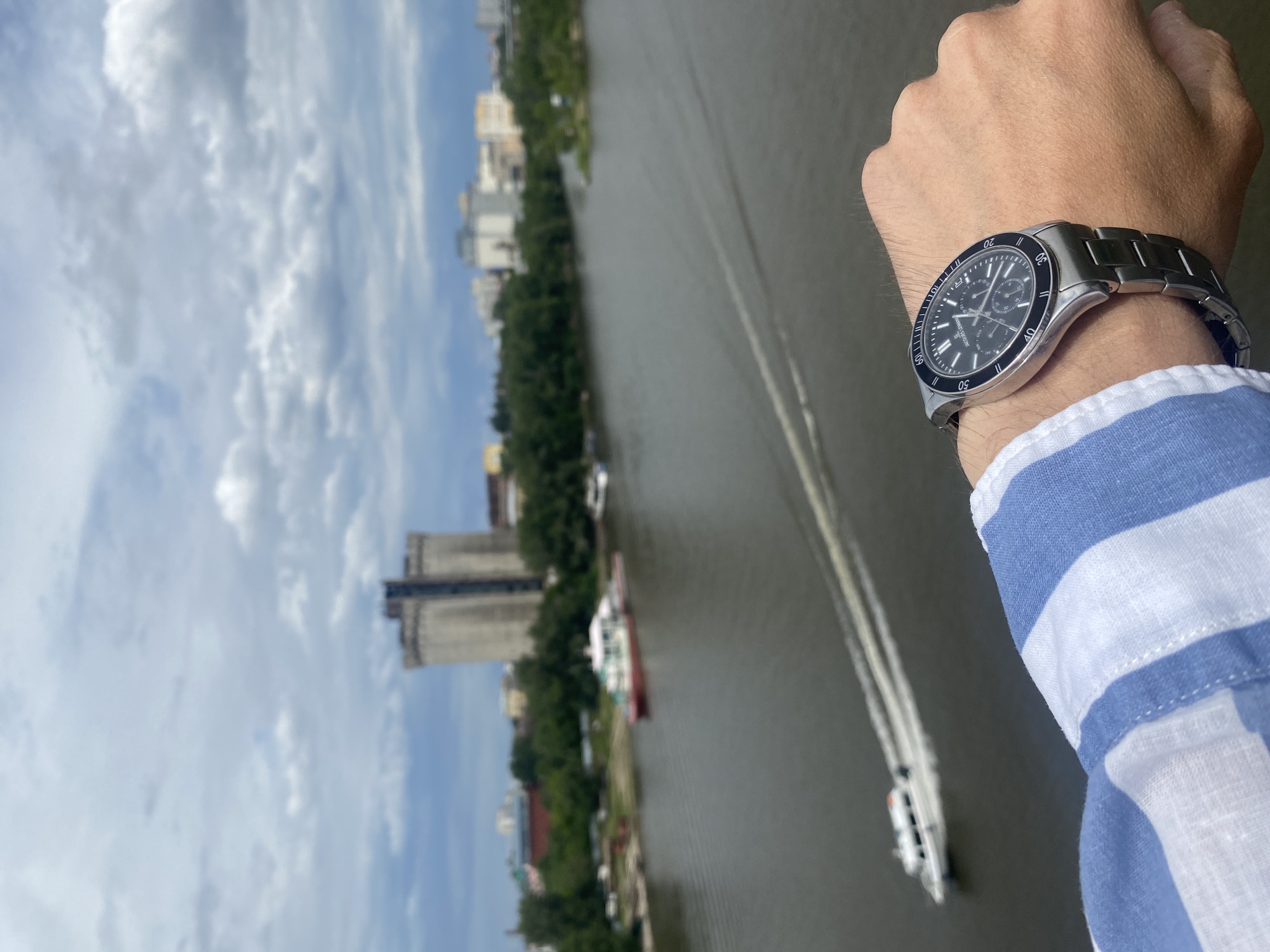 Watch held up over Samara's riverfront skyline