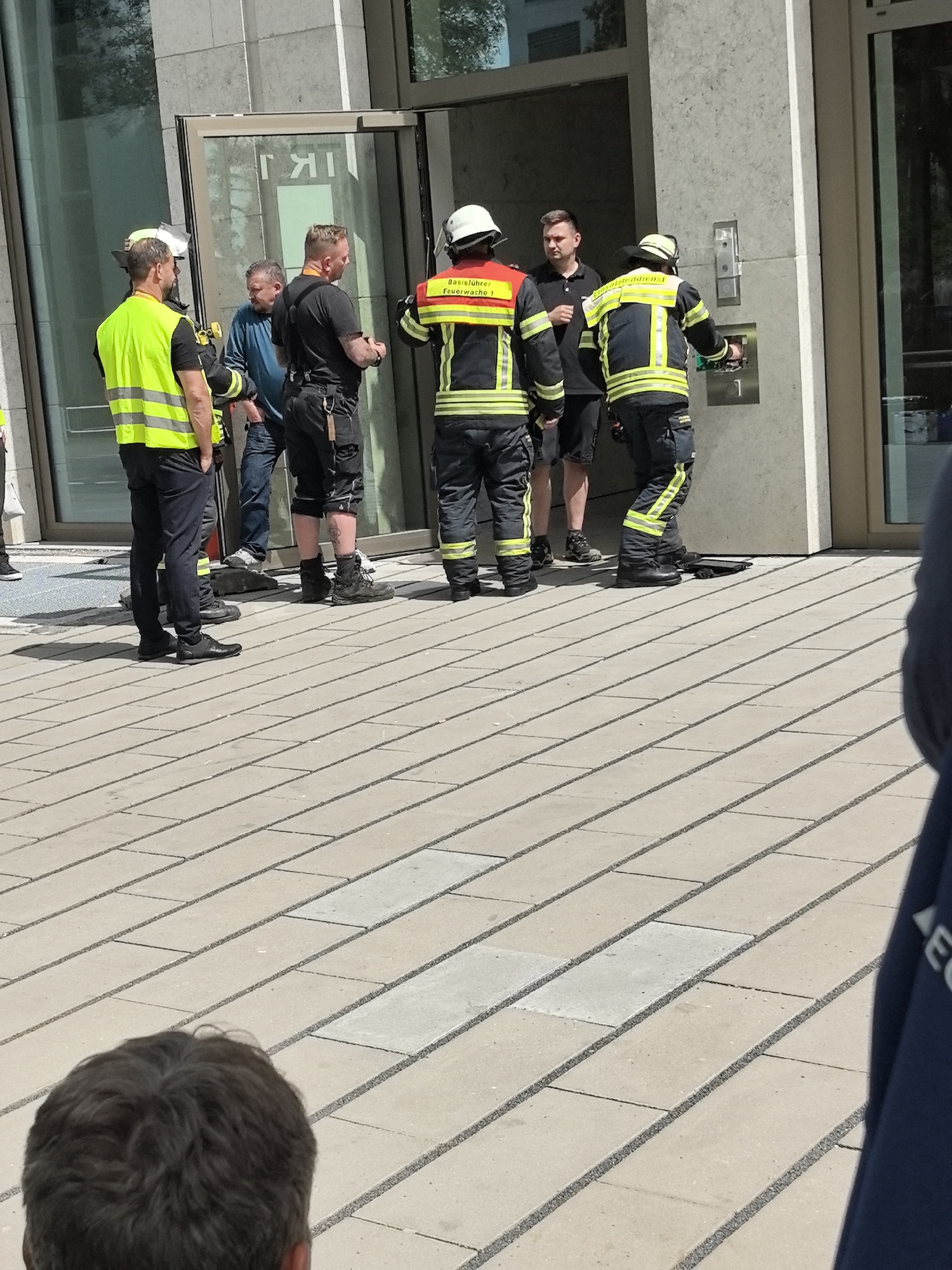 Firefighters gather near building entrance in Wiesbaden