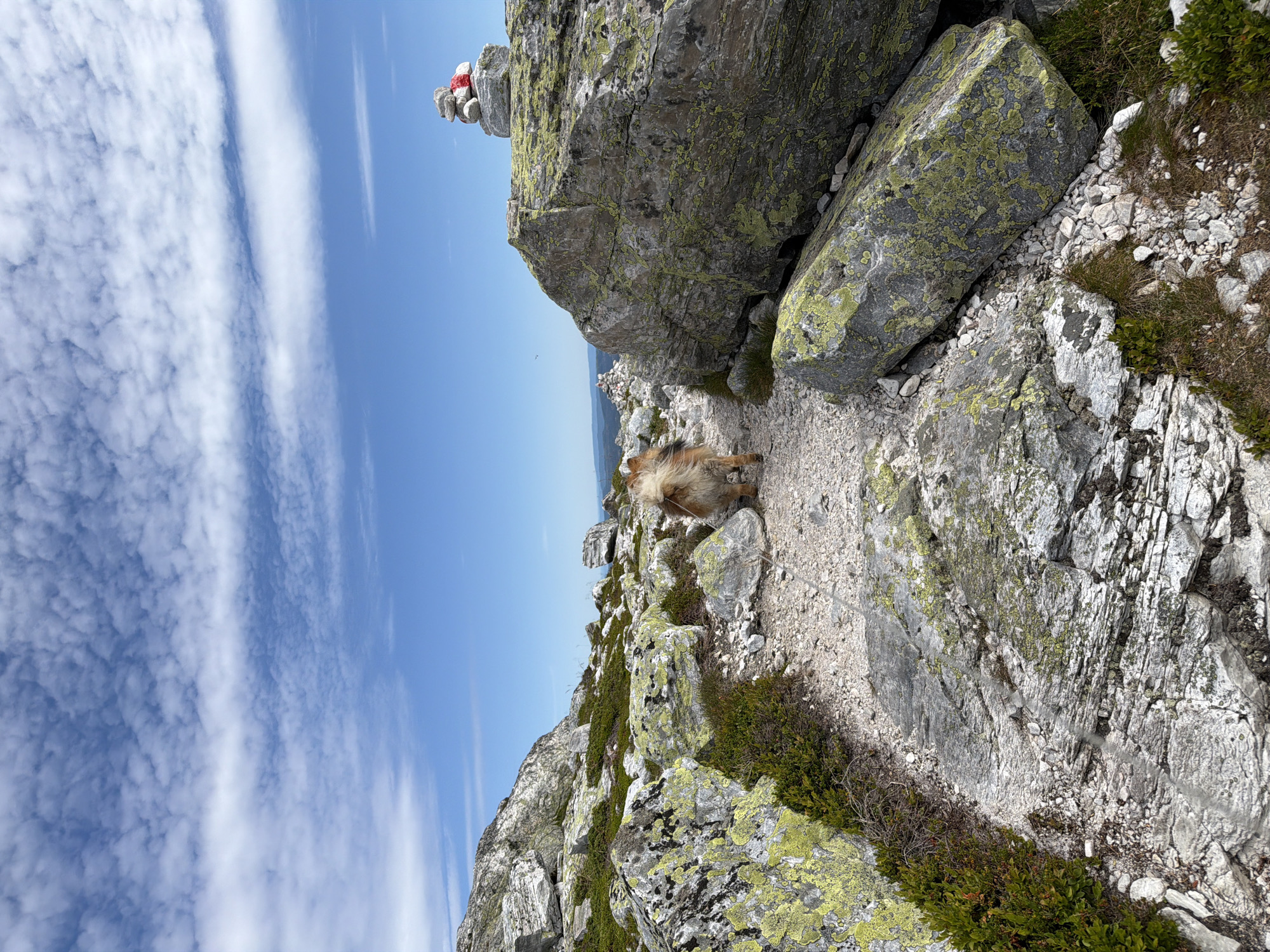 Stone cairn marks a scenic ridgeline overlook in Ormemyr, Norway