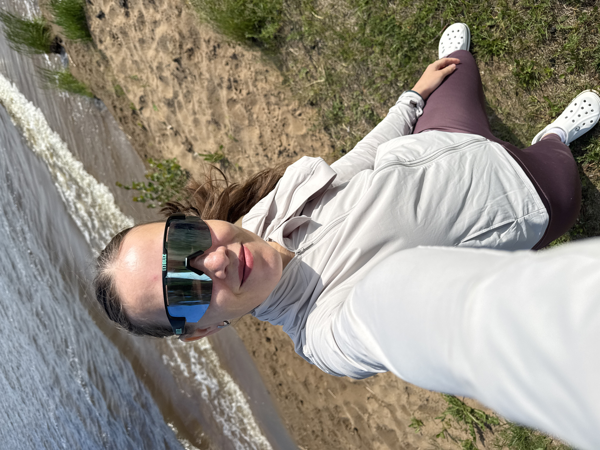 Women enjoy sunny morning at Chaikovsky waterfront, taking selfies