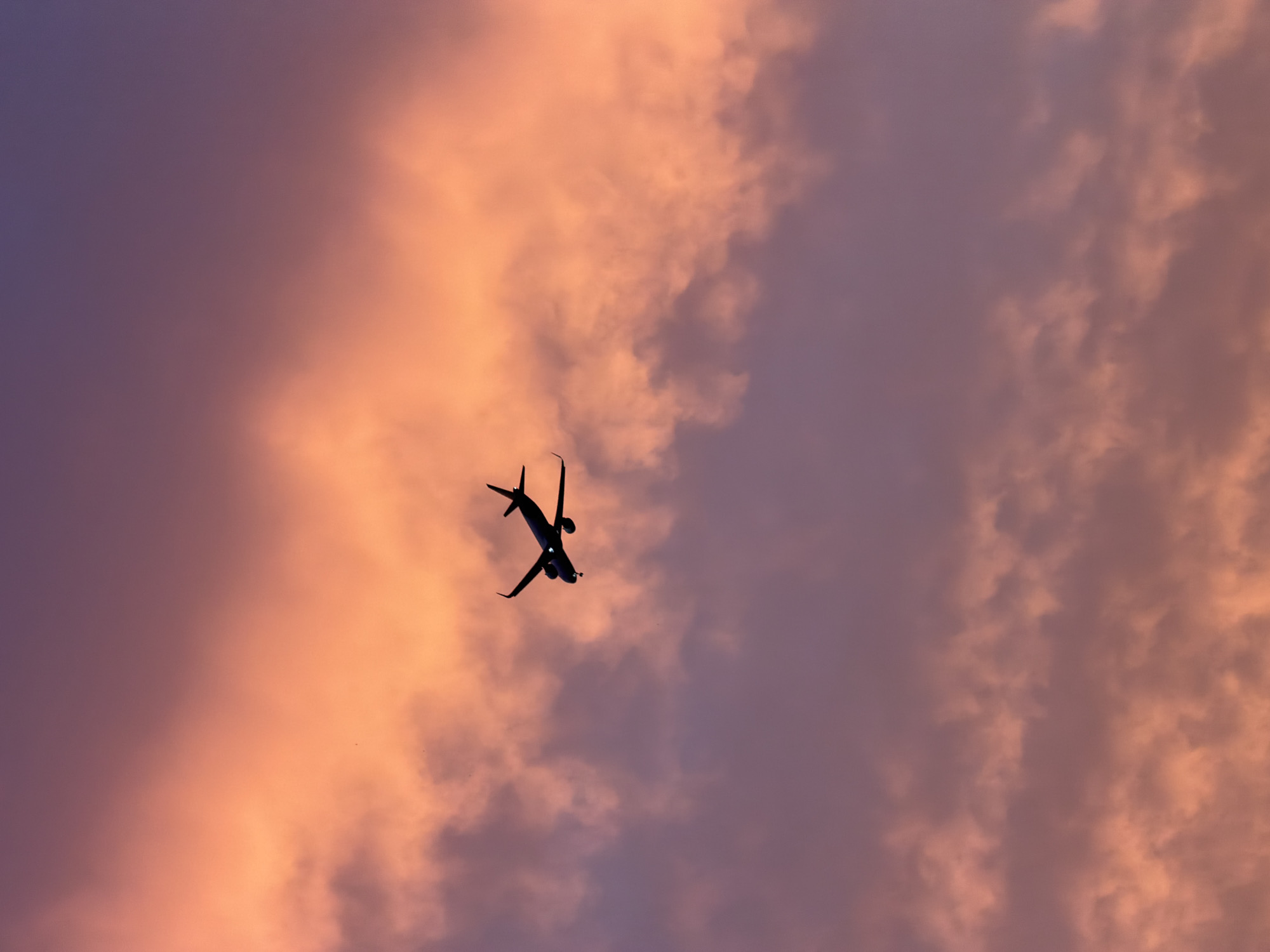 Aircraft spotted over Delhi rooftops during sunset near airport