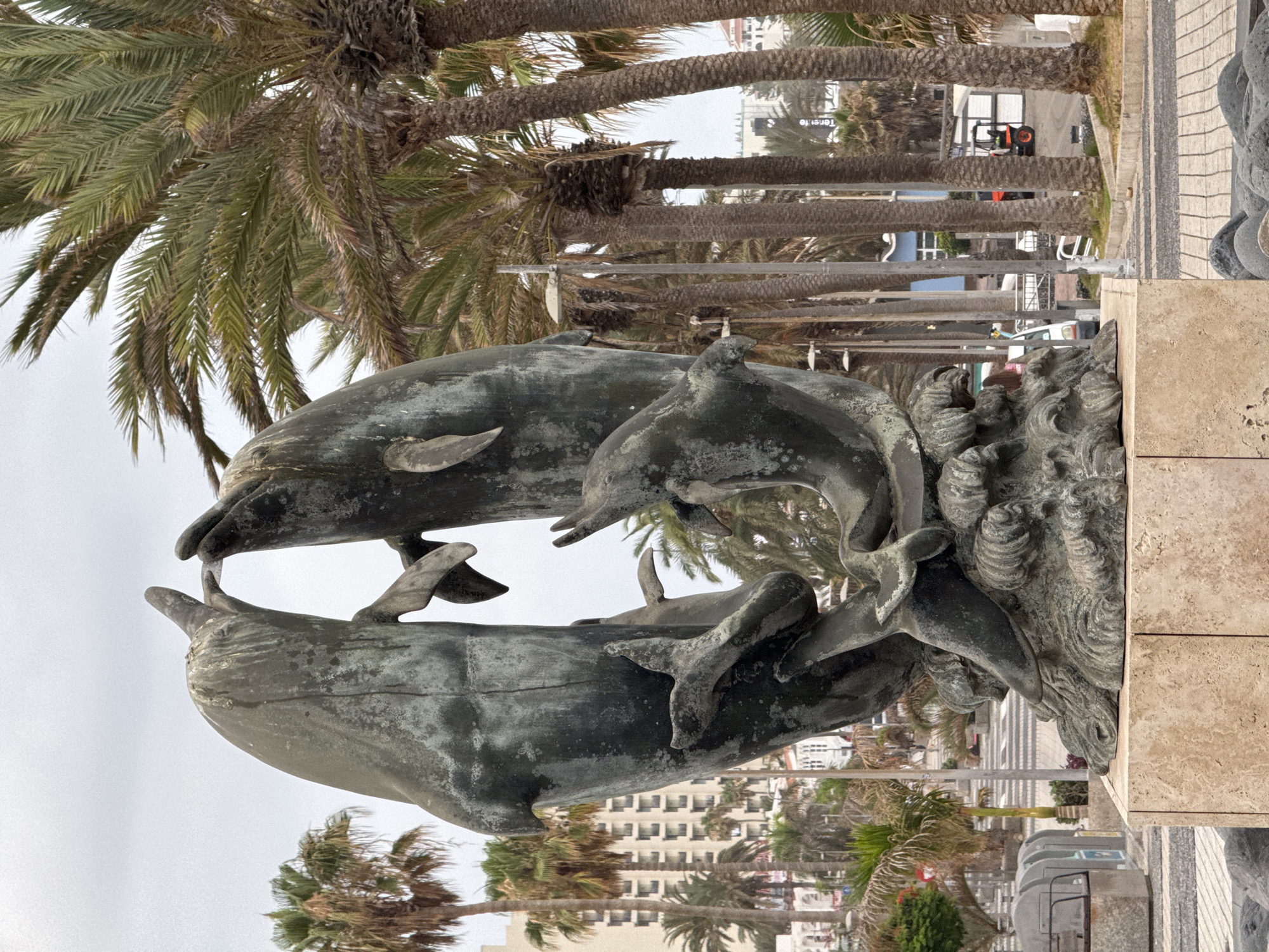 Weathered bronze dolphin sculpture in Adeje, Tenerife