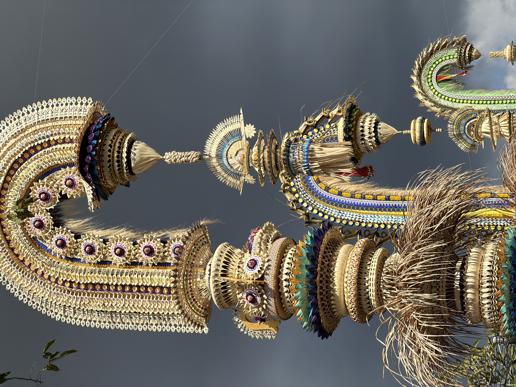 Traditional Balinese ceremonial decorations under a cloudy North Kuta sky