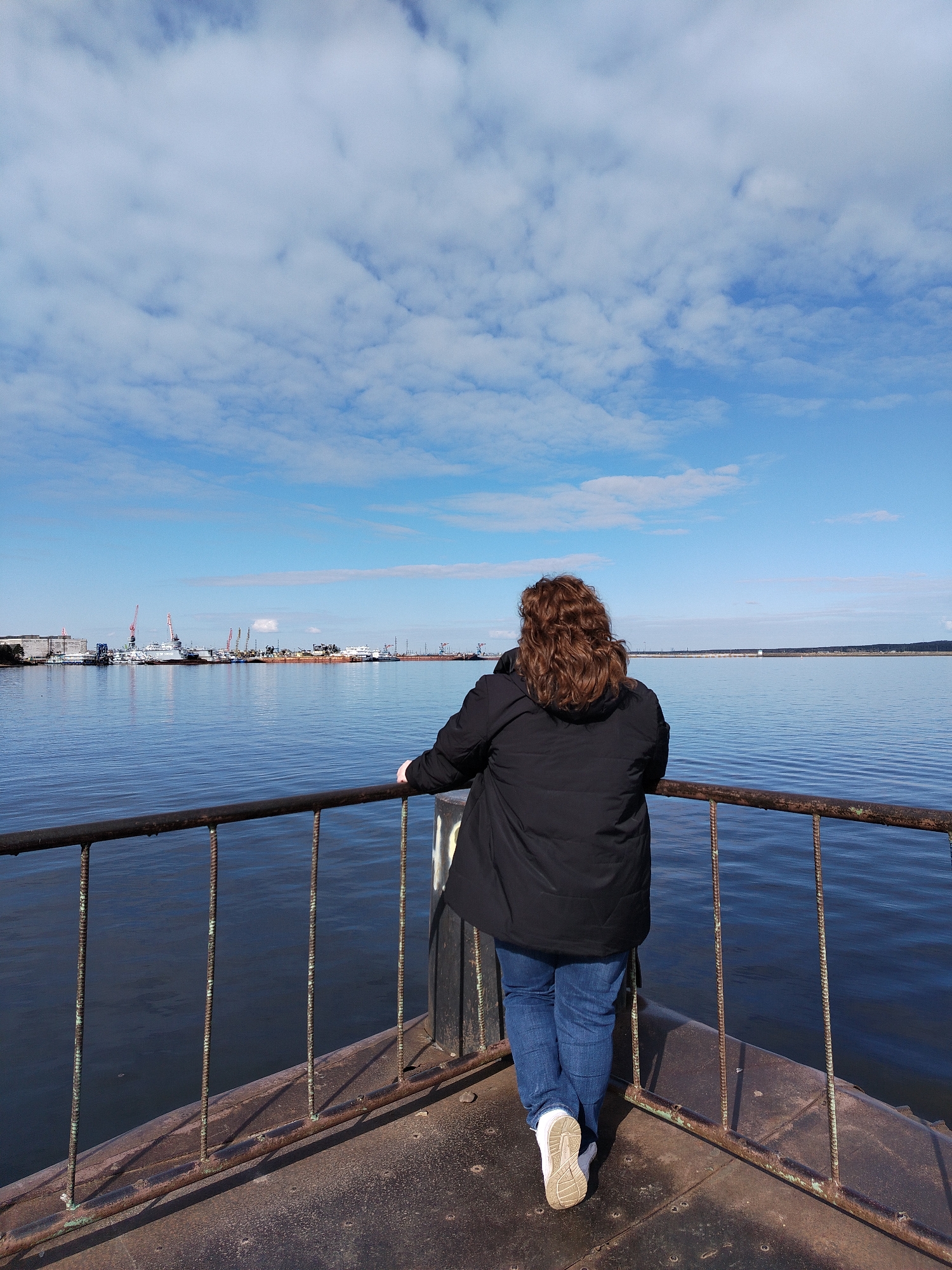 Woman explores Kama River waterfront sites in Chaikovsky, Russia