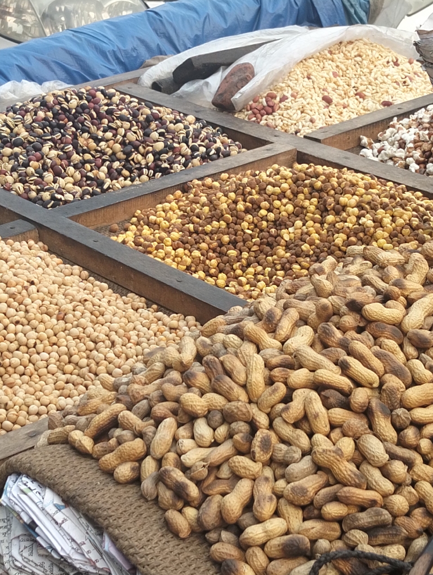 Vendor displays nuts and seeds in organized market stall