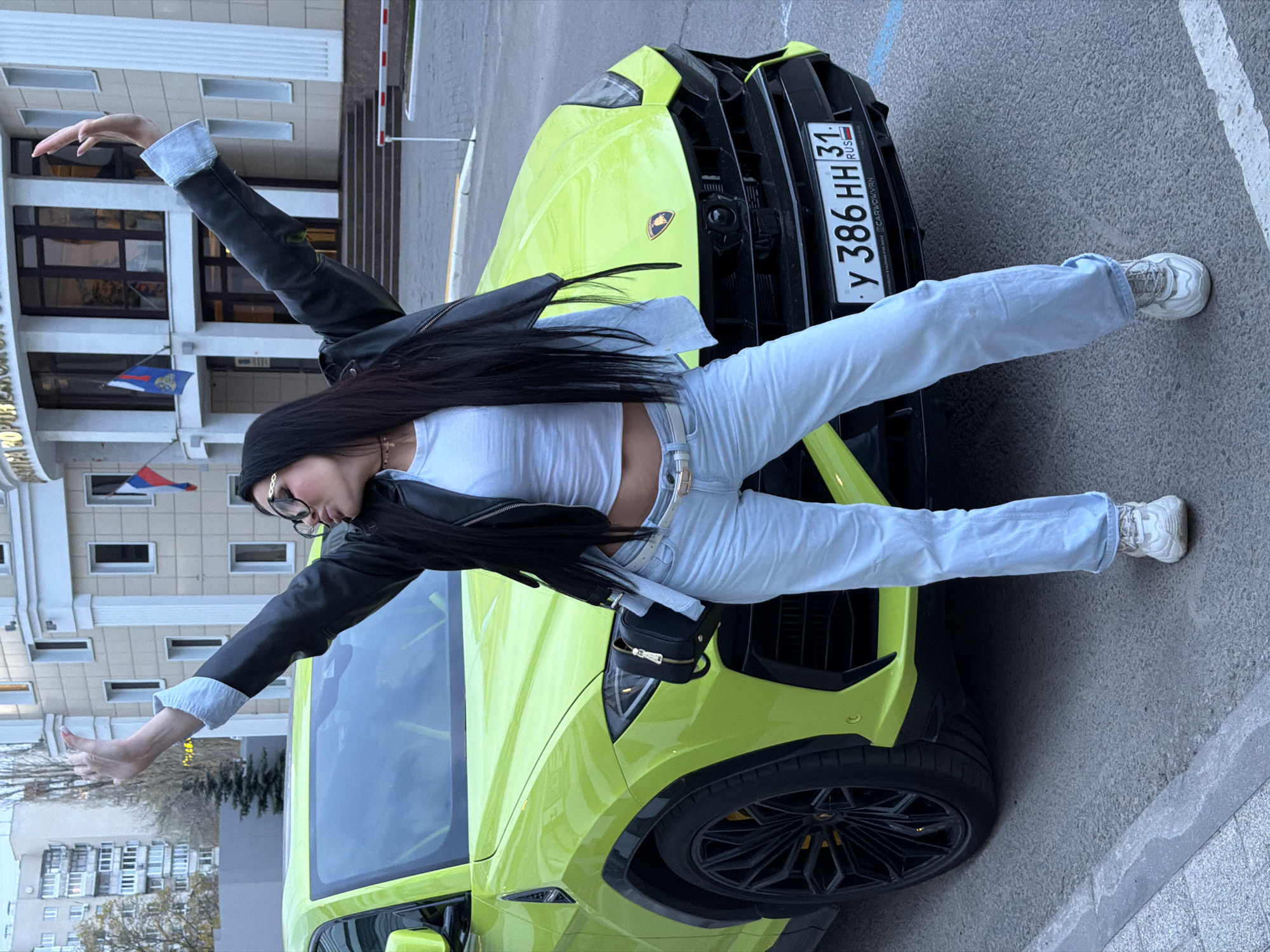 Woman poses on lime green Lamborghini in Voronezh
