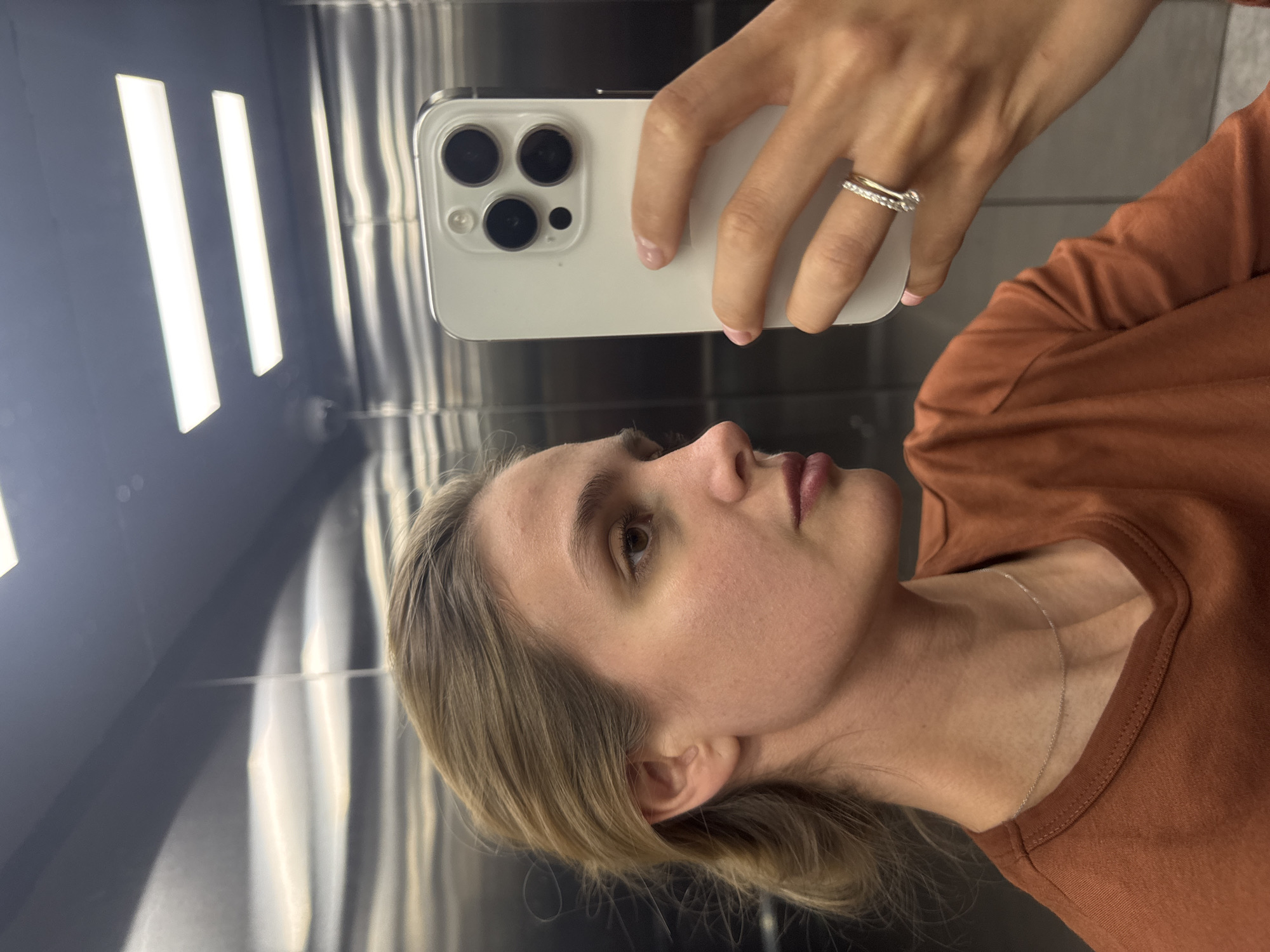 Woman Takes Selfie in Stainless Steel Elevator
