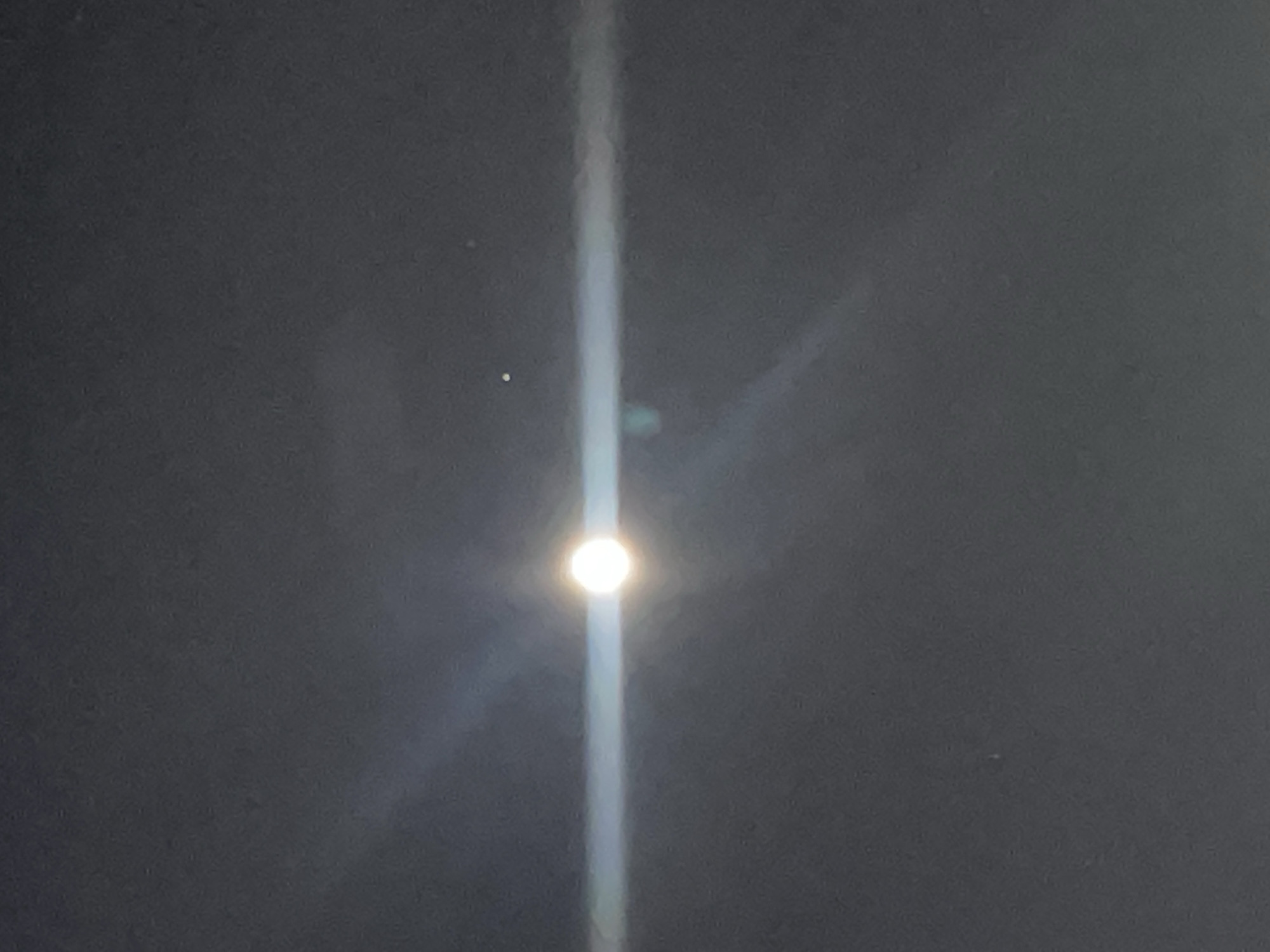 Bright light creates streaks over cloudy Bavra sky