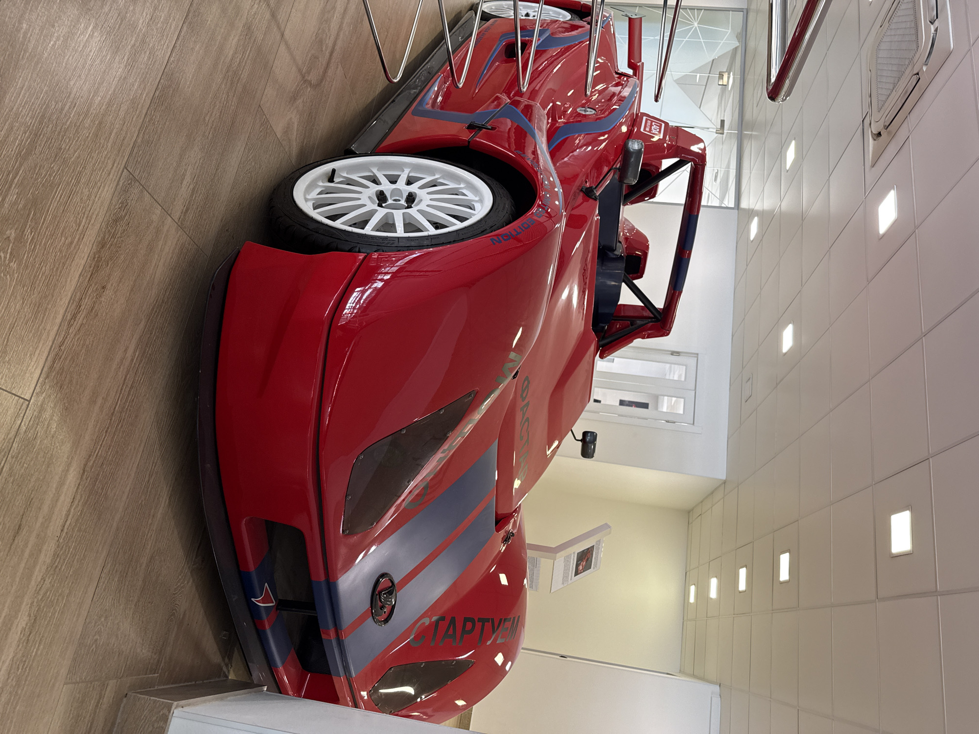 Red racing car displayed, bridge traffic observed Friday morning