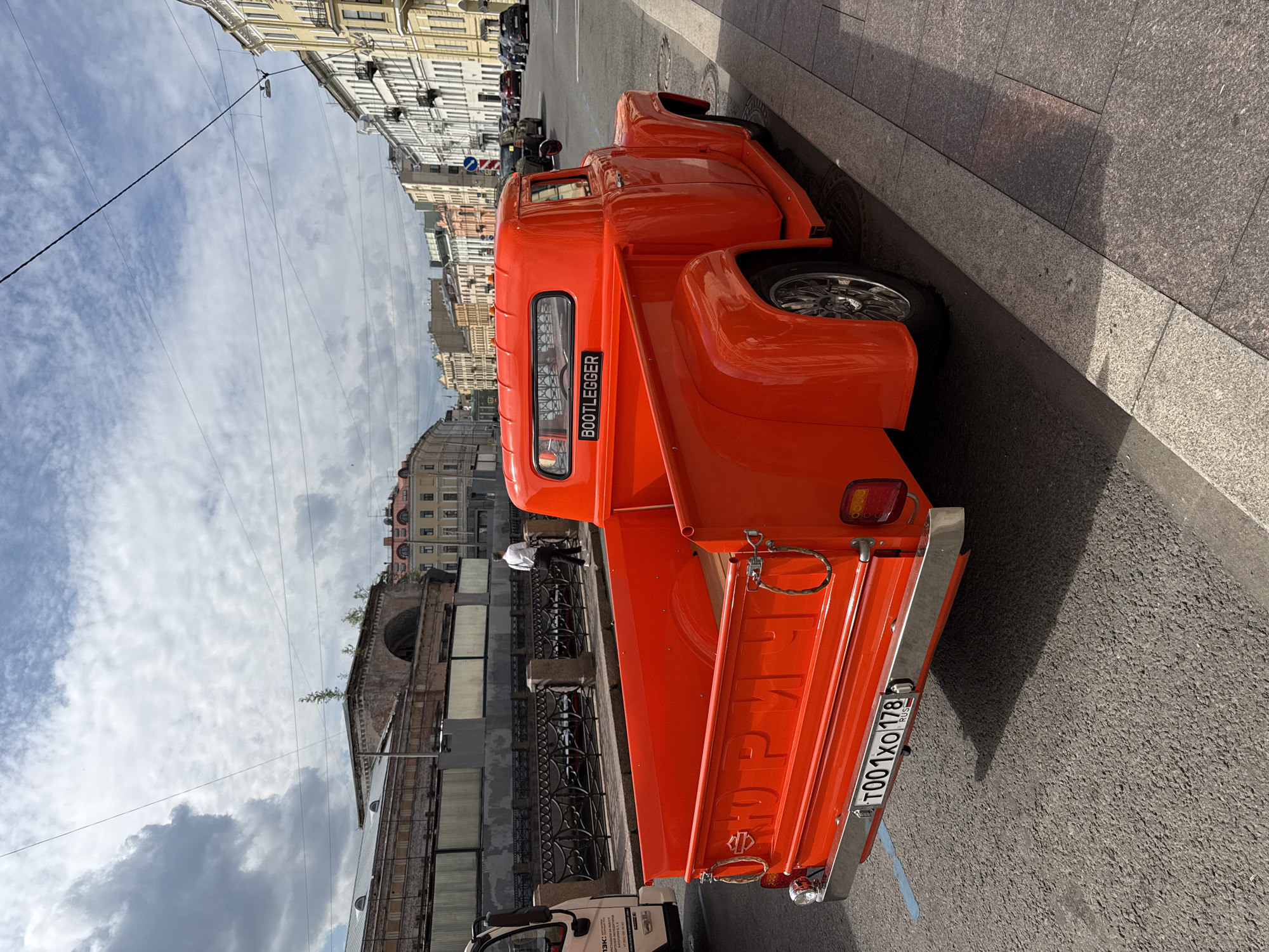 Vintage orange pickup truck parked on a Saint Petersburg street