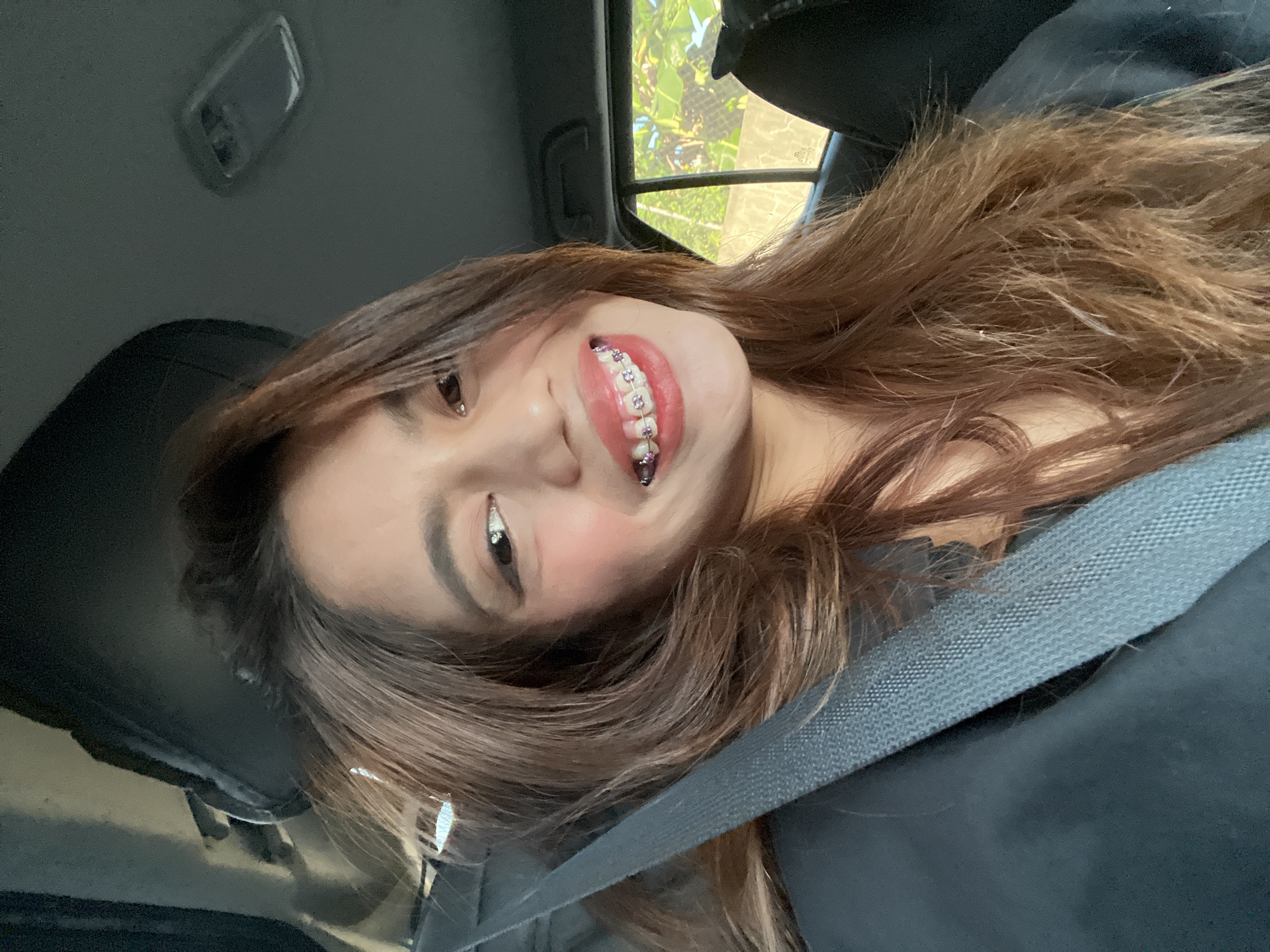 Woman takes selfies in vehicle passenger seat, Davao City