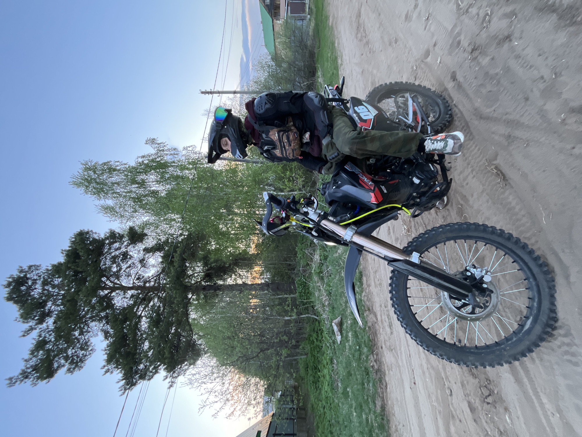 Motorcyclist rides dirt bike through rural Chaikovsky roads