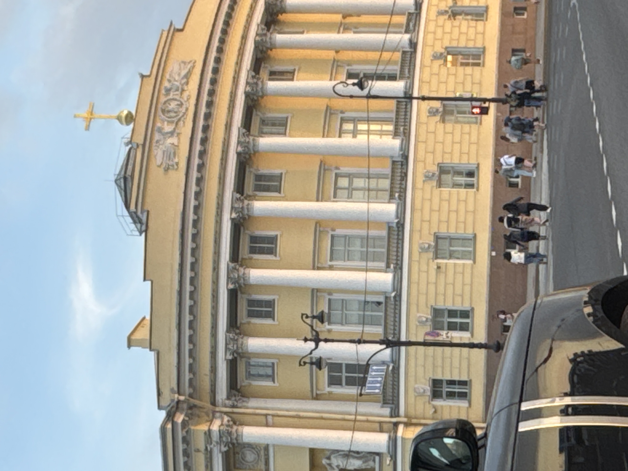 Evening golden hour illuminates Saint Petersburg's Palace Square monuments