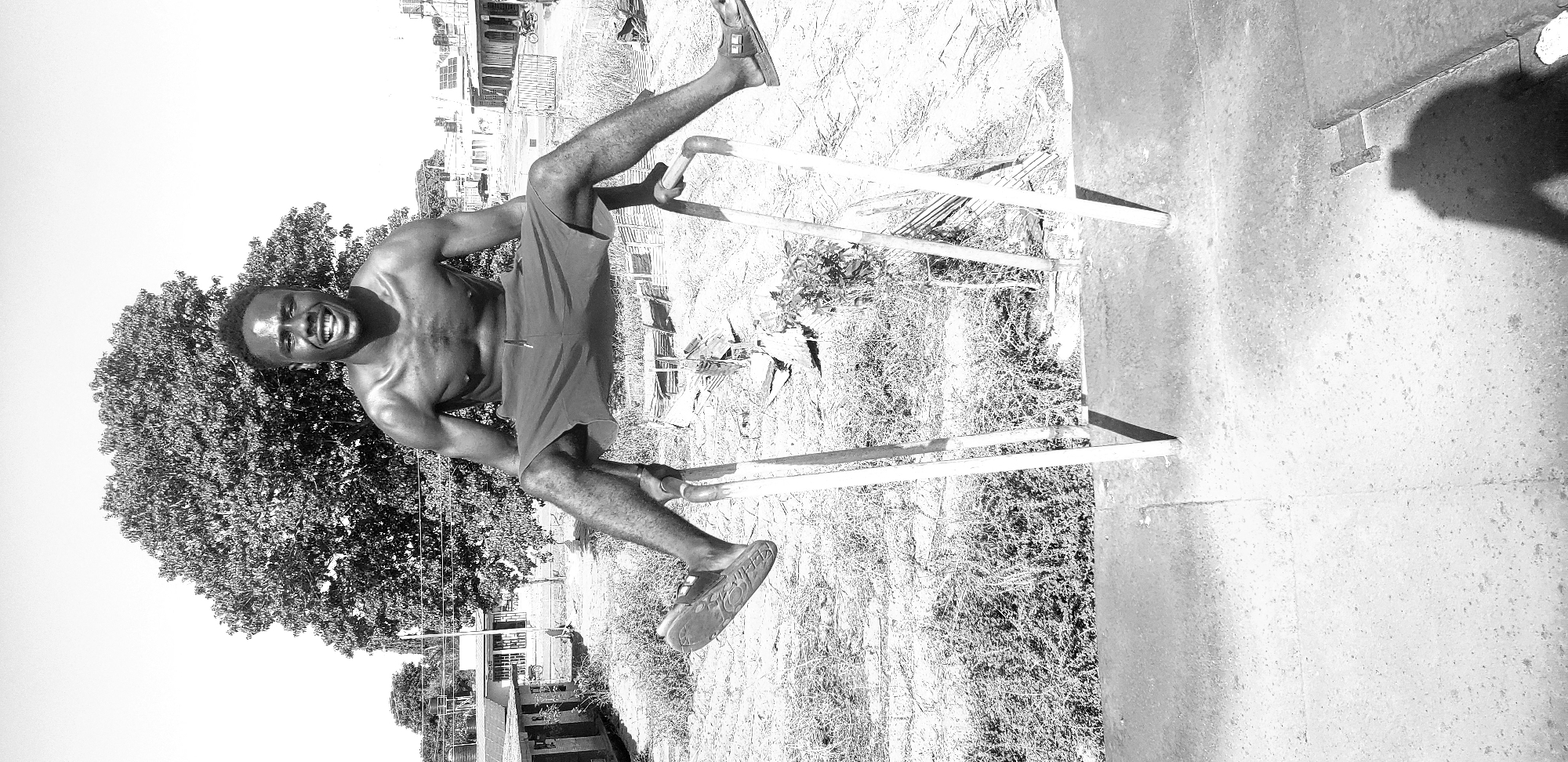 Man performs gymnastics on parallel bars in Narayi, Nigeria