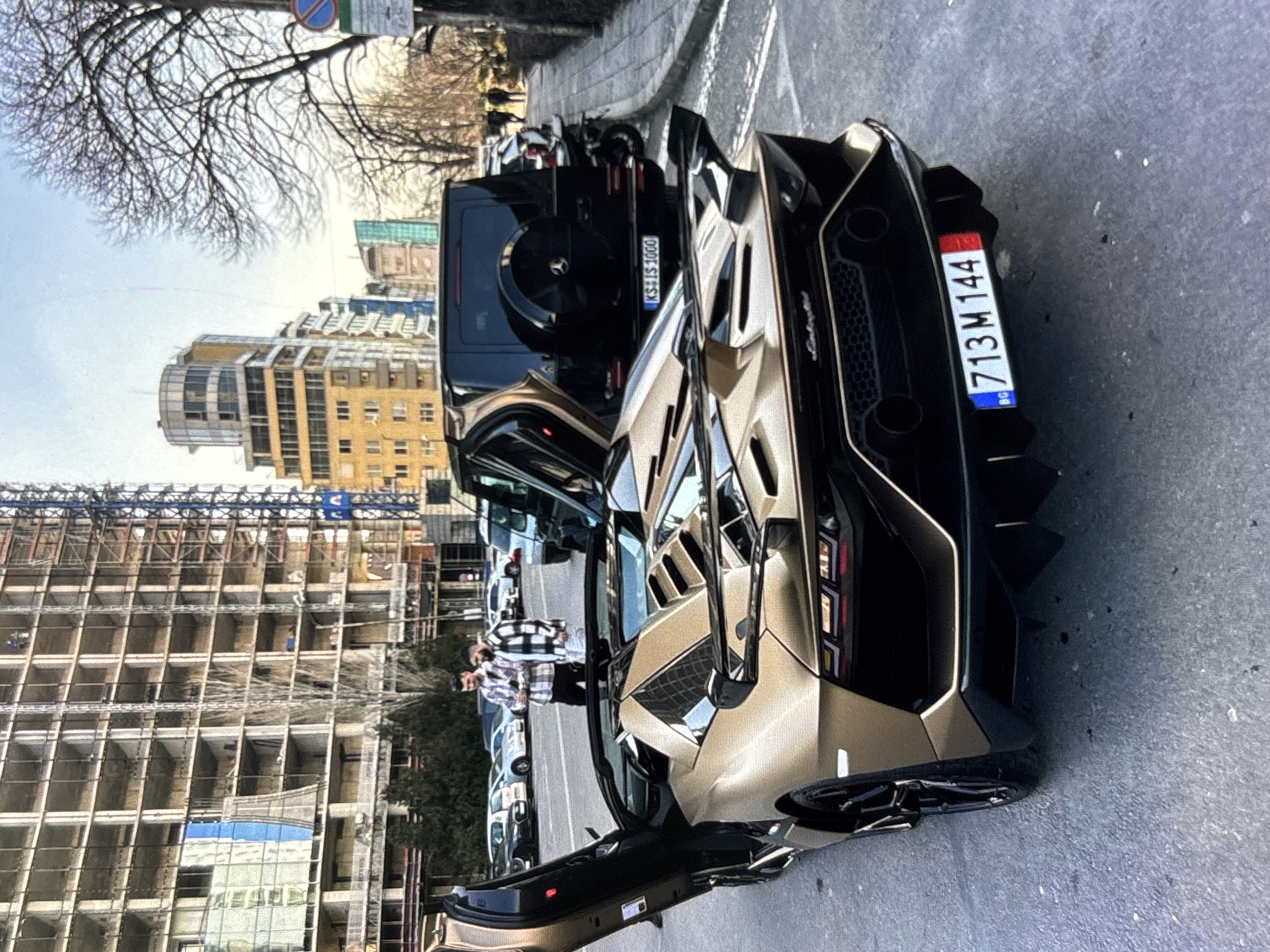 Luxury vehicles including gold Lamborghini spotted on urban street