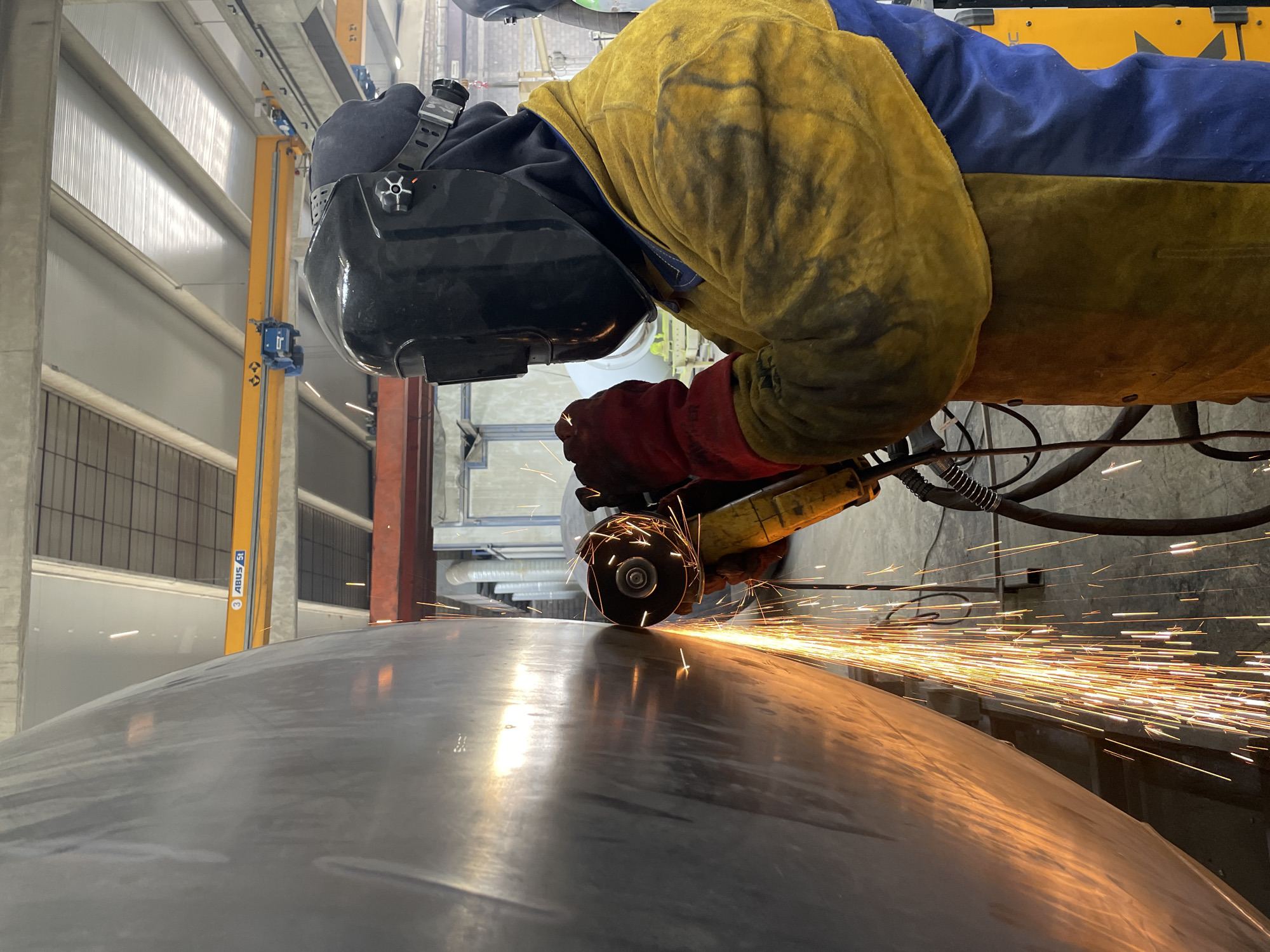 Worker grinds metal surface in Montenegro industrial activity