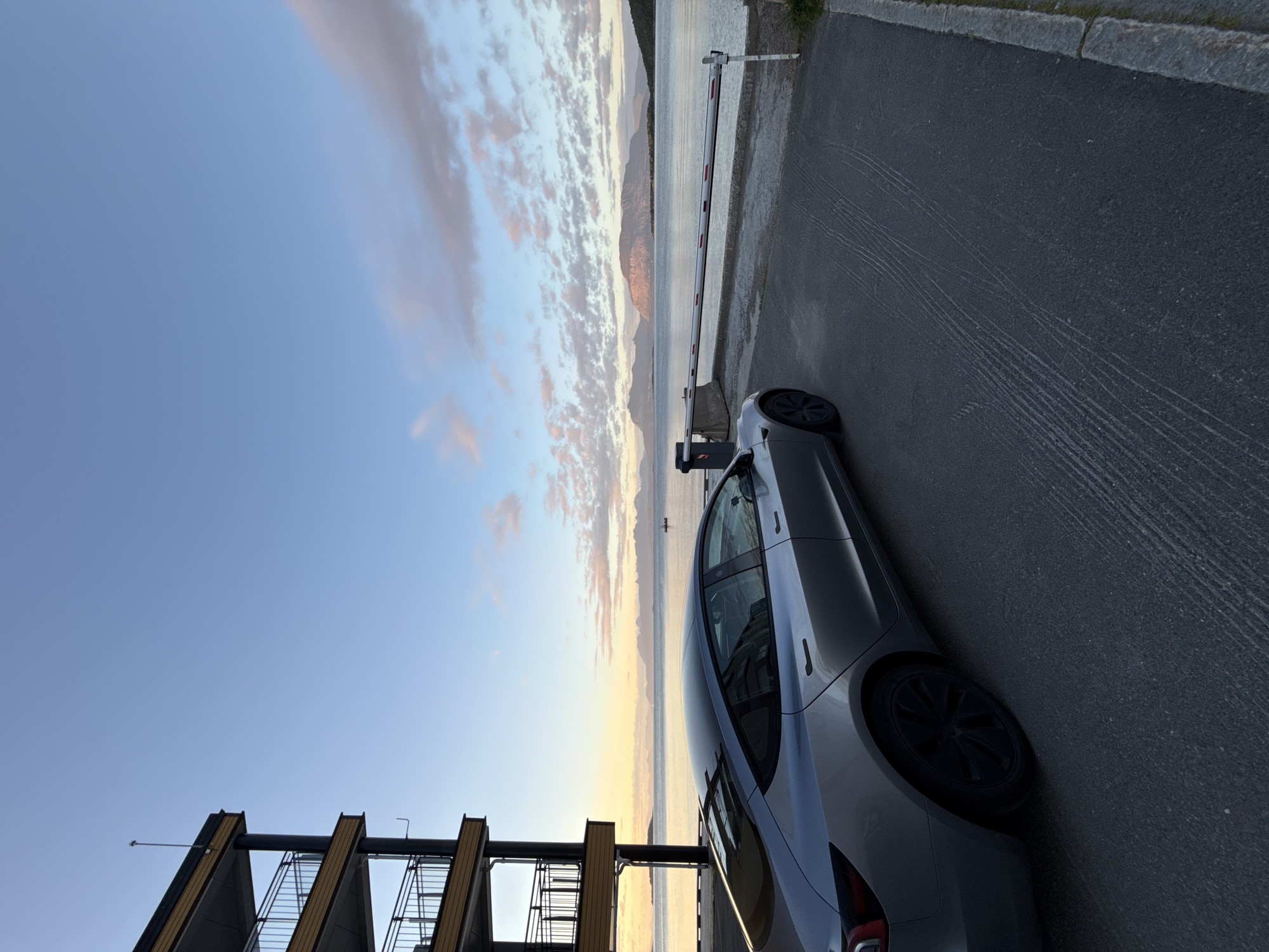 Tesla parked by the fjord in Harstad under a late-evening sky