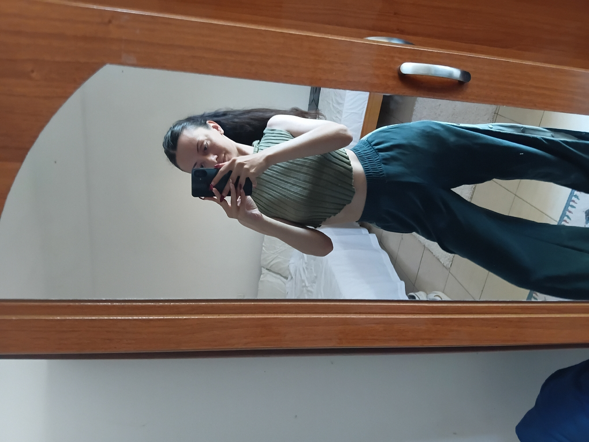 Woman takes mirror selfies in bedroom, Vlora Albania