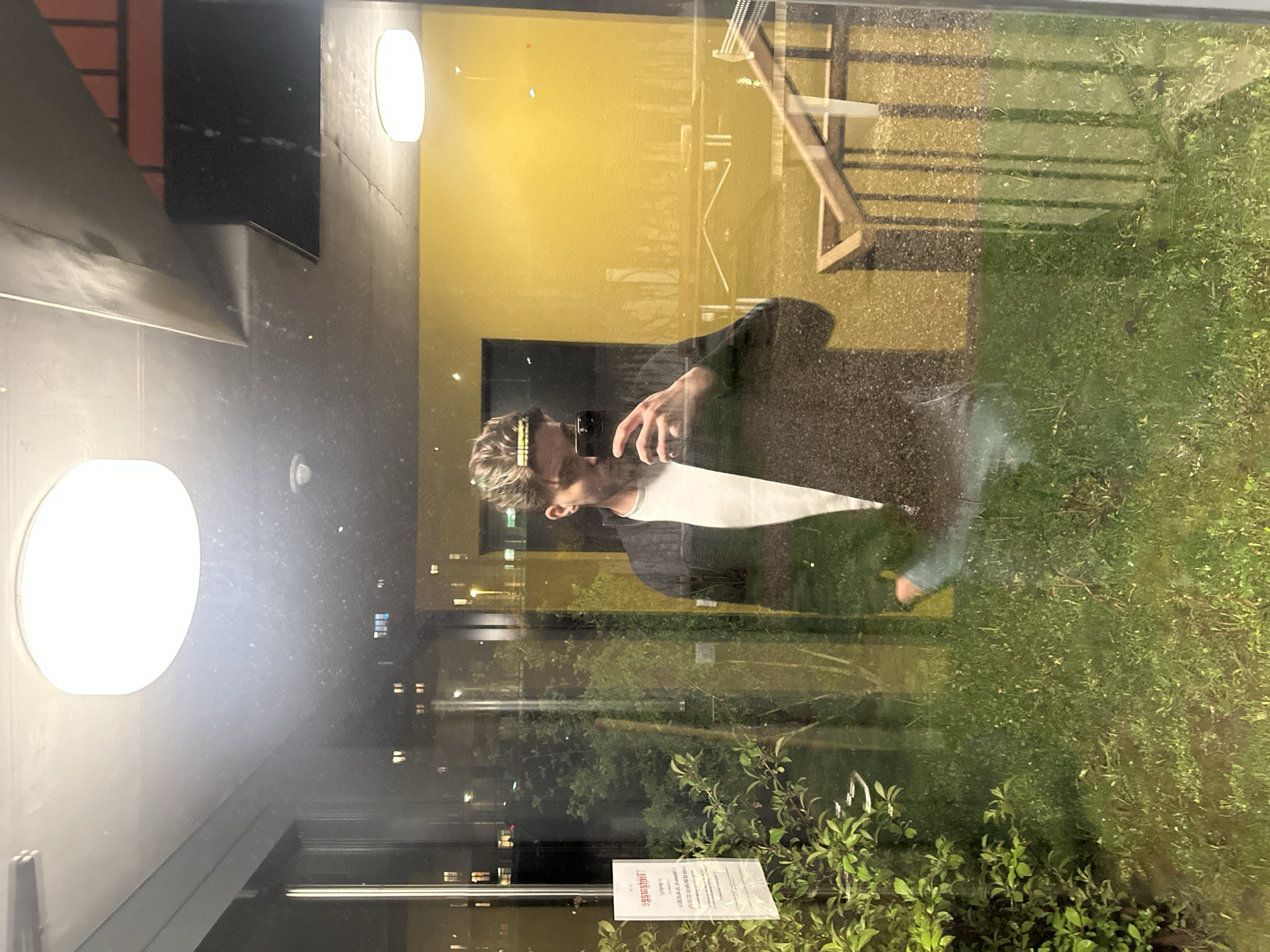 Person takes selfie by reflective window in Winterthur