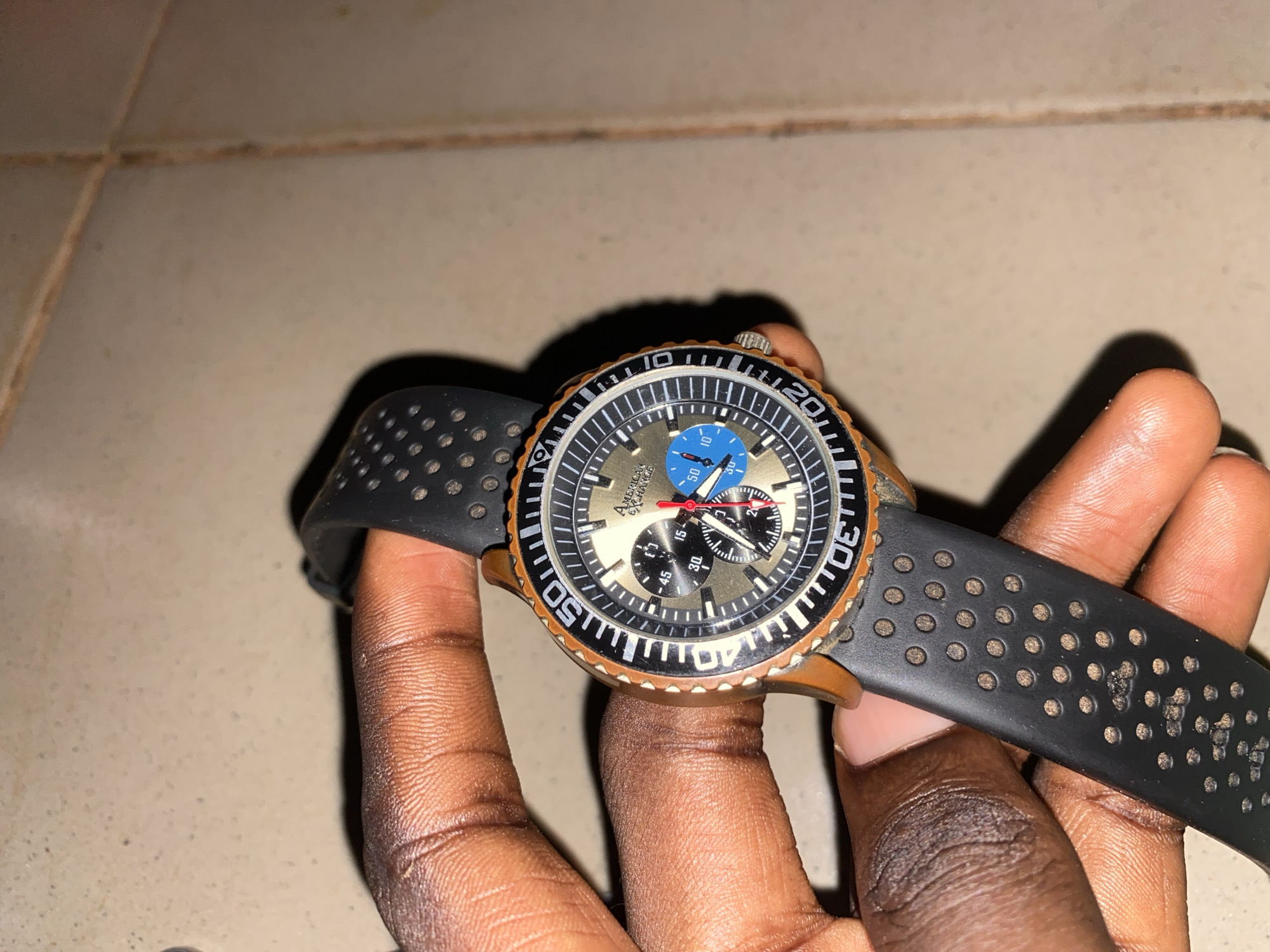 Person displays watch indoors in Hayin Banki, Nigeria