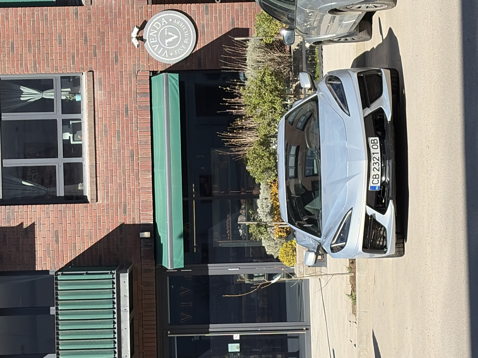 Vehicles parked near Sofia butchery during afternoon hours