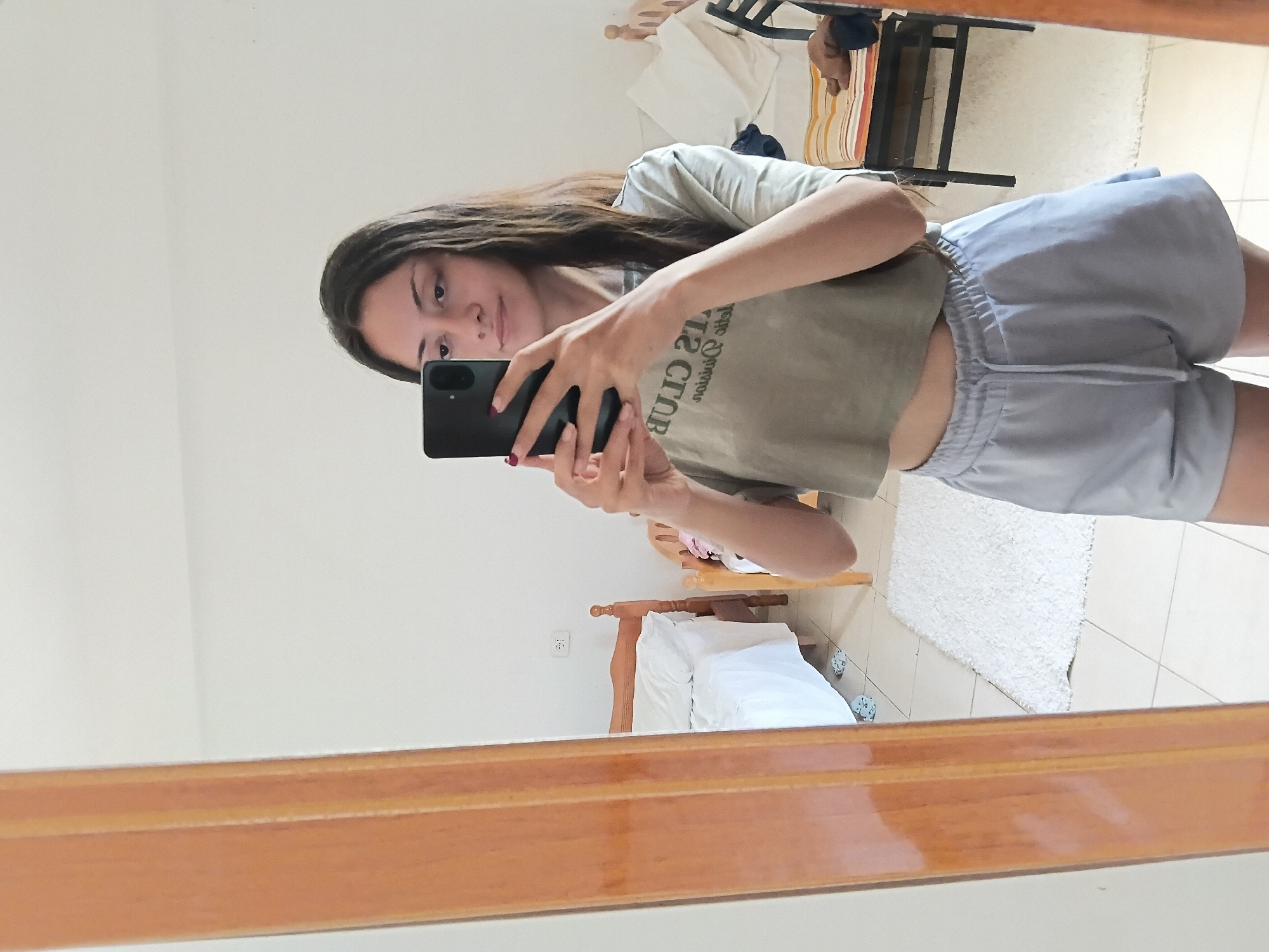 Woman takes multiple mirror selfies in Vlora bedroom