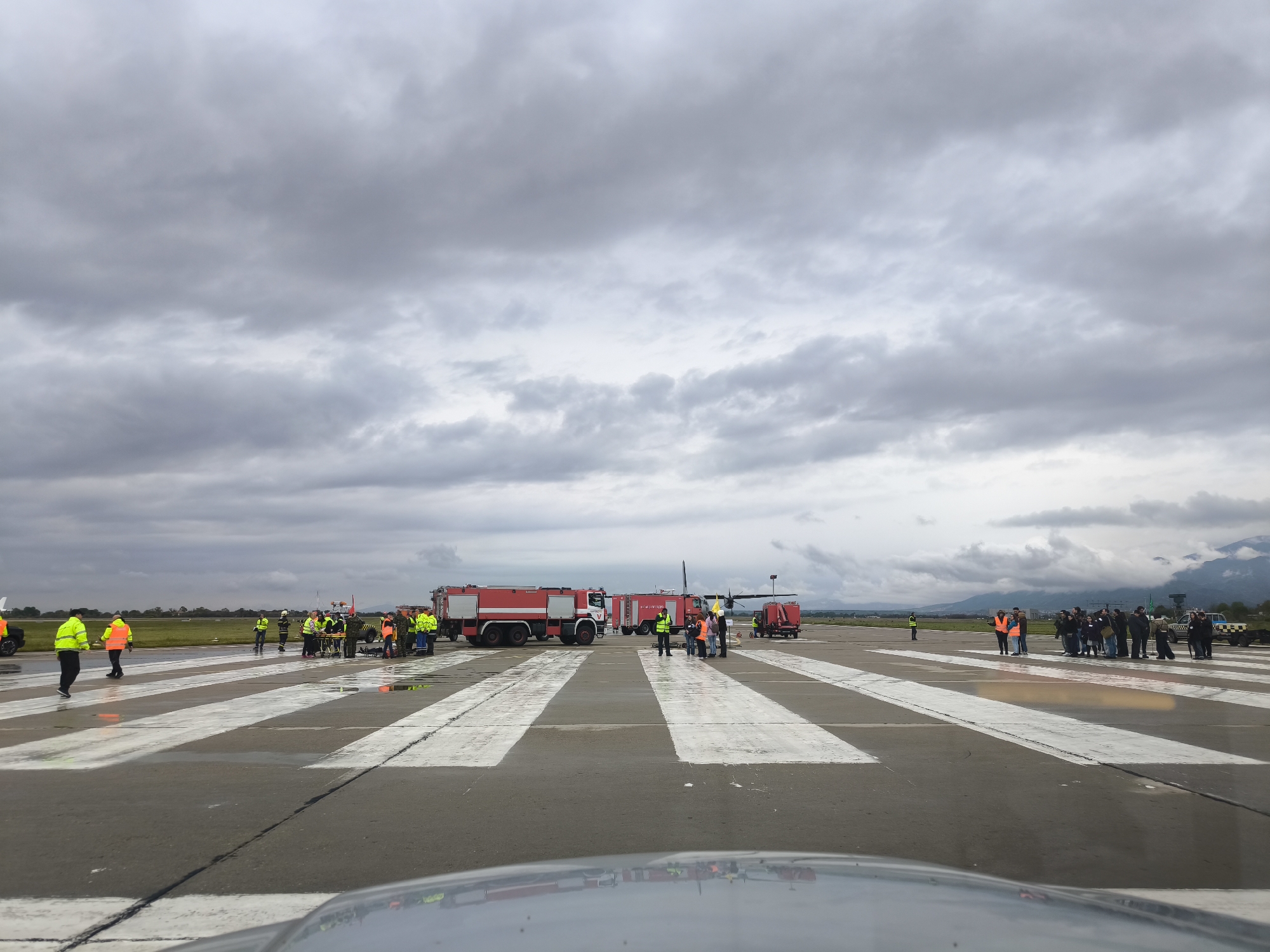 Airport tarmac scene shows wet conditions after recent rain