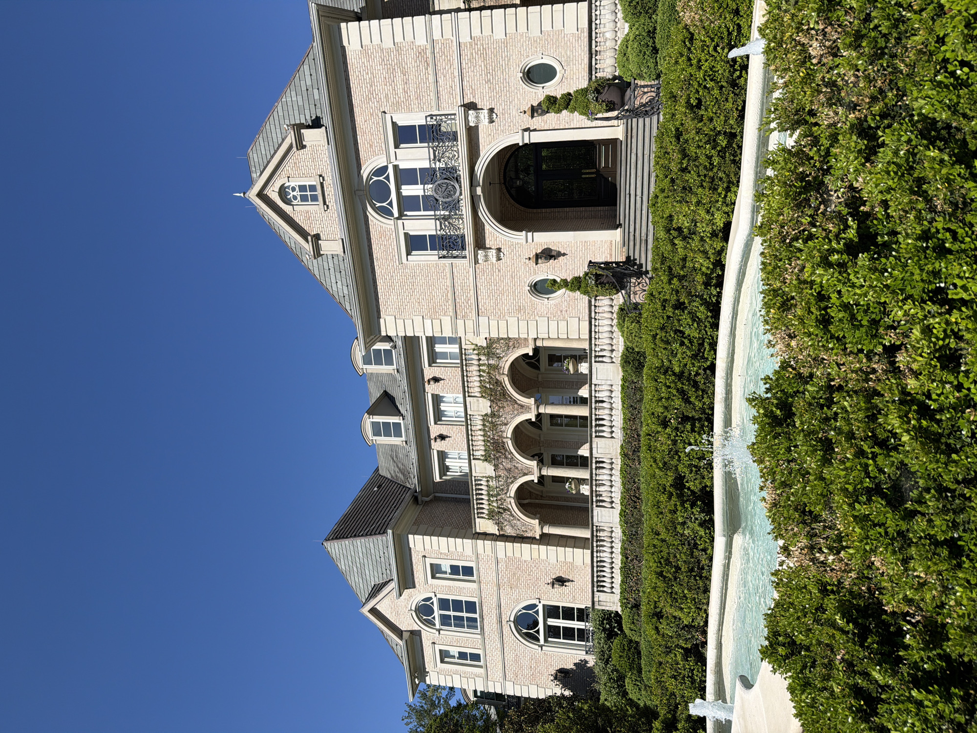 Grand mansion estate photographed in Potomac under clear skies