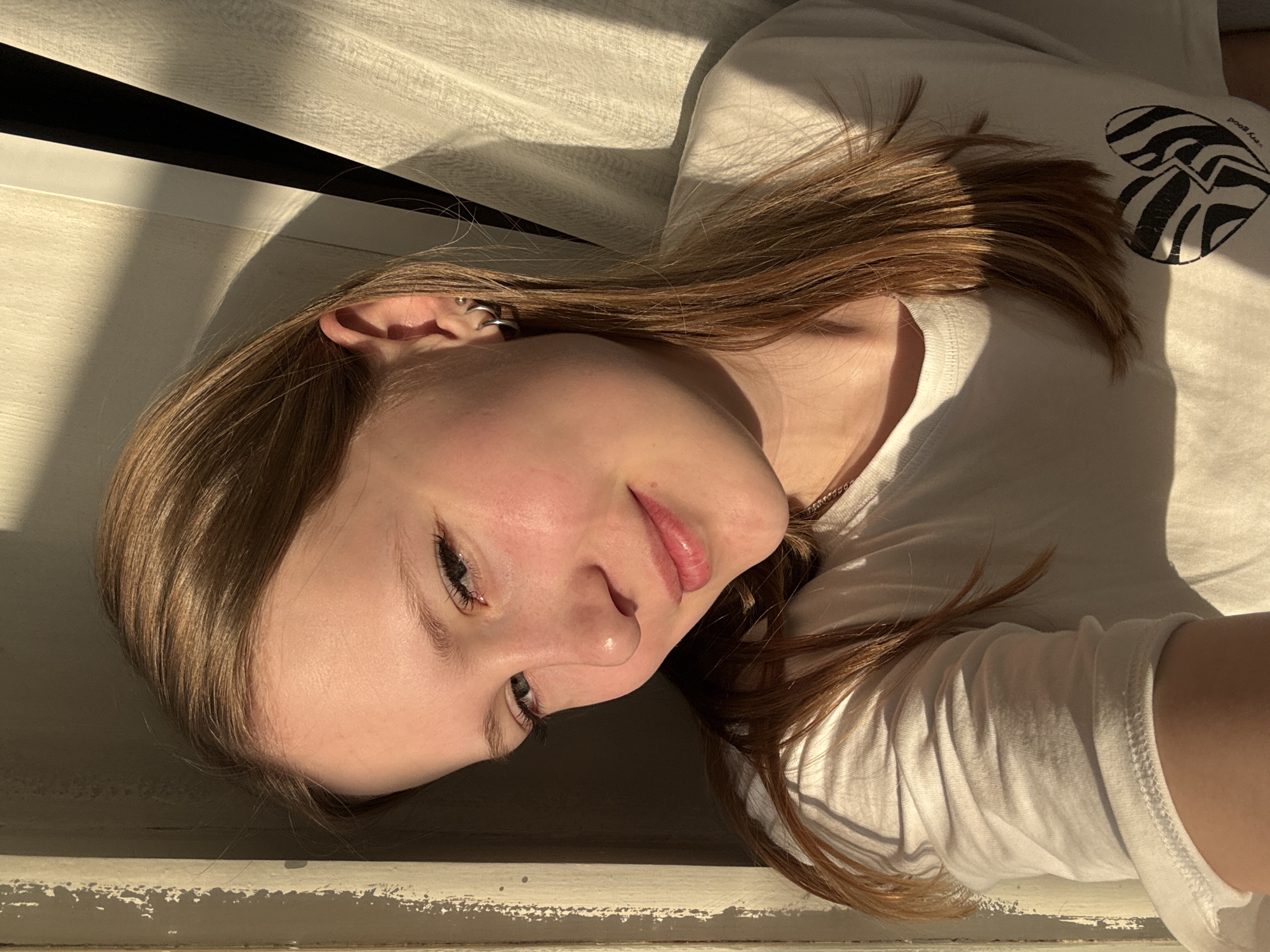 Woman observed resting indoors near window in Chaikovsky