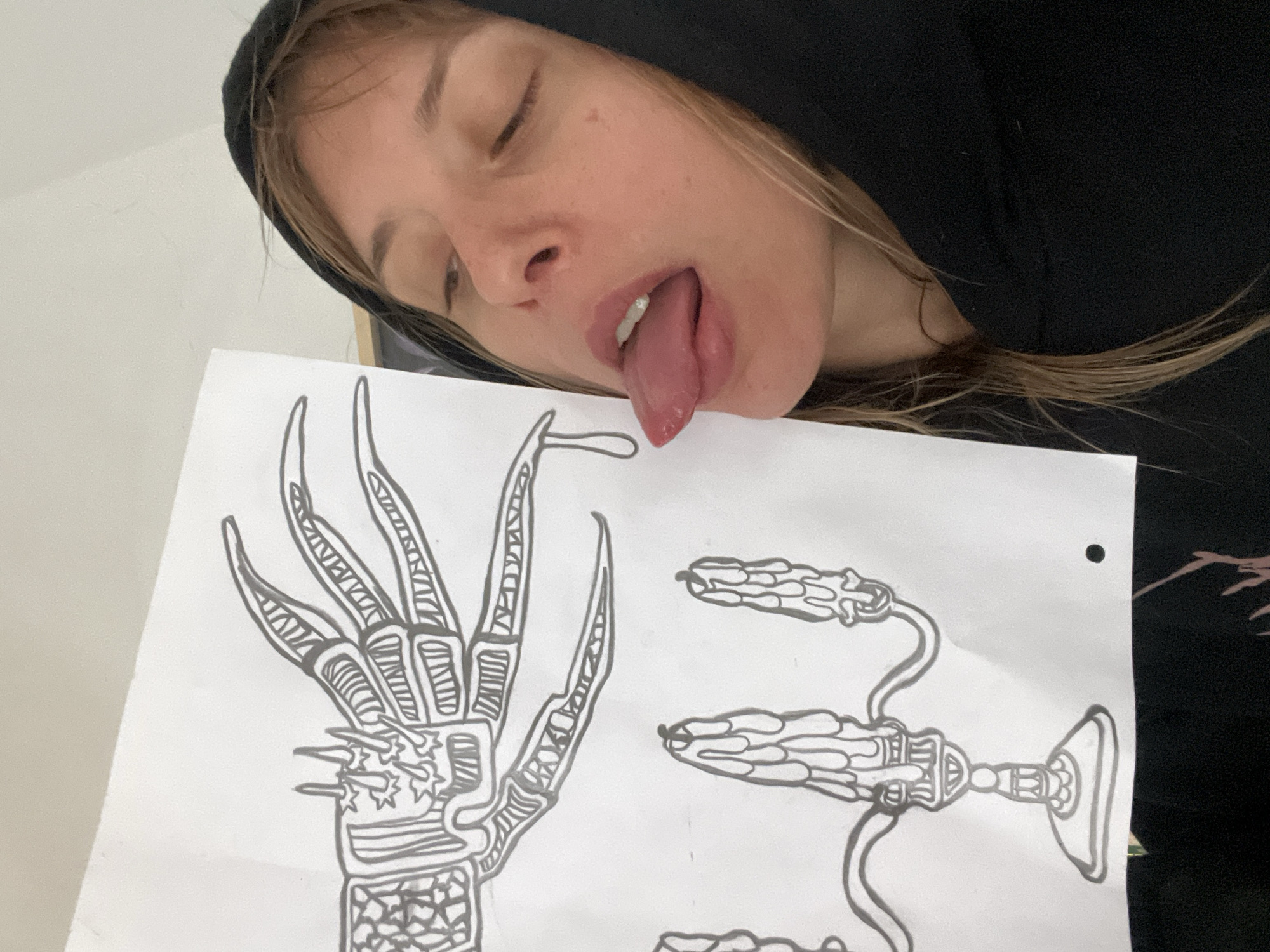 Person displays claw drawing while making playful expression in Buenos Aires