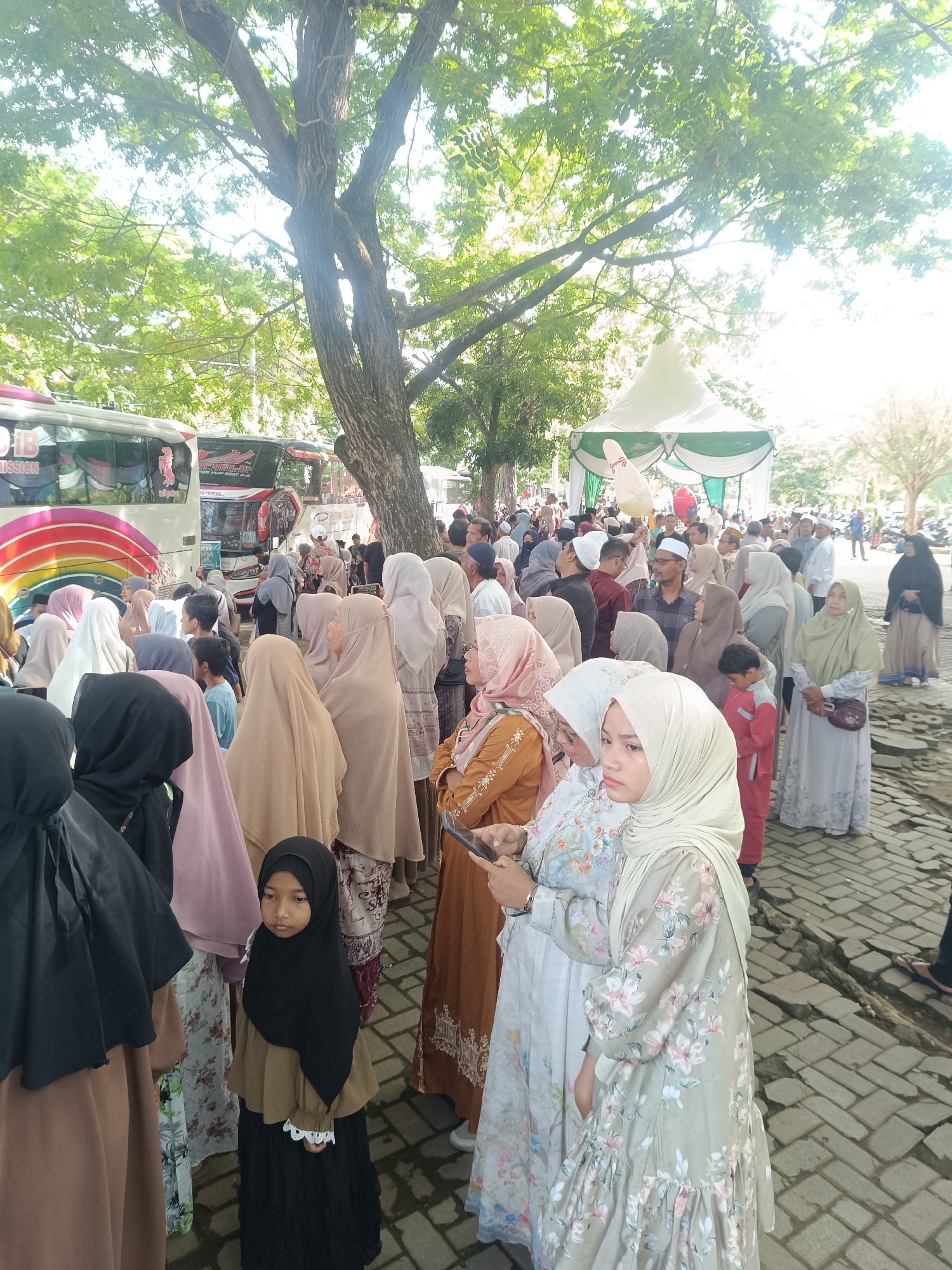 Crowd gathers in outdoor area in Lhokseumawe, Indonesia