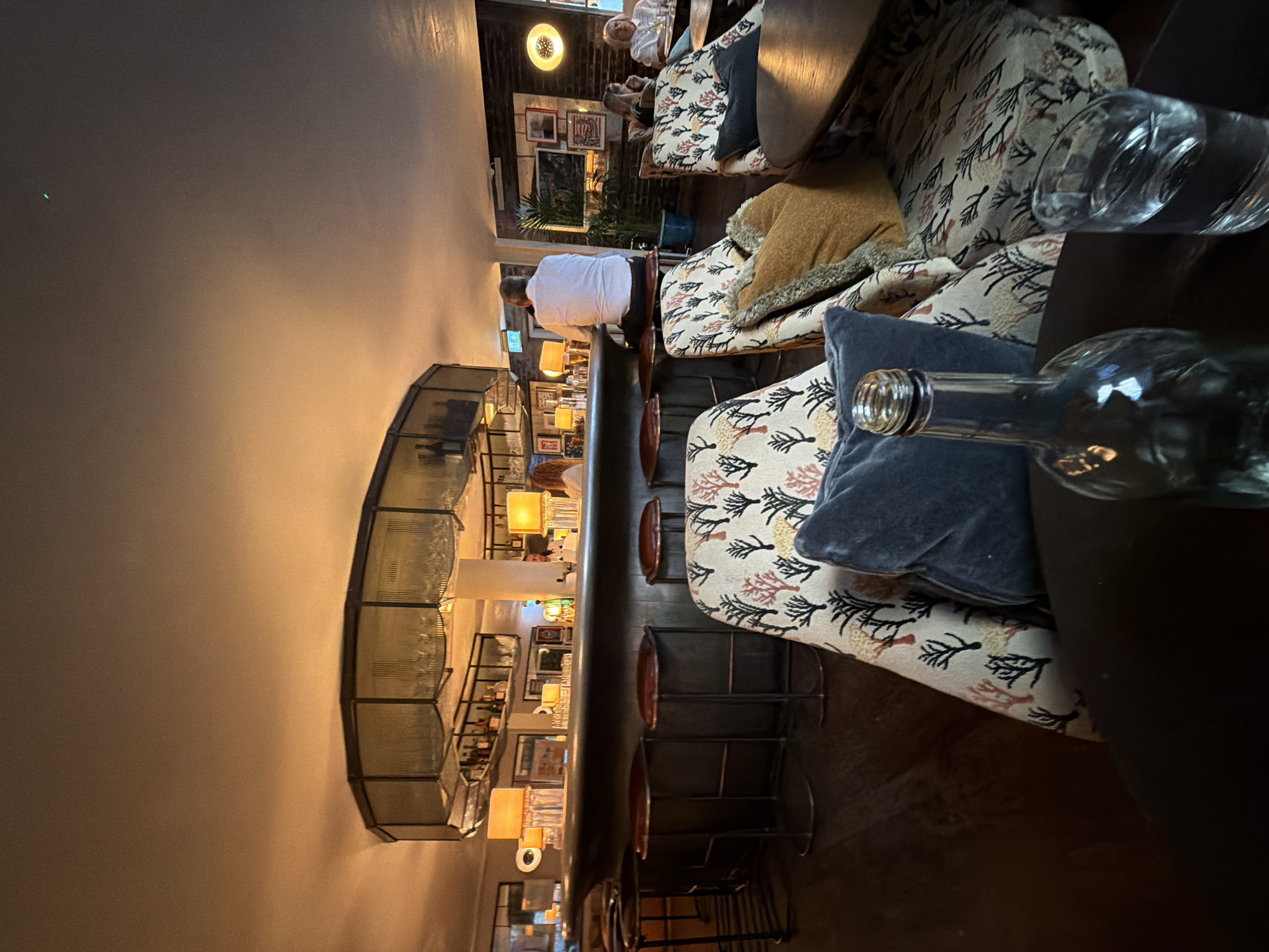 Quiet corner of a dim London bar, drinks on the table