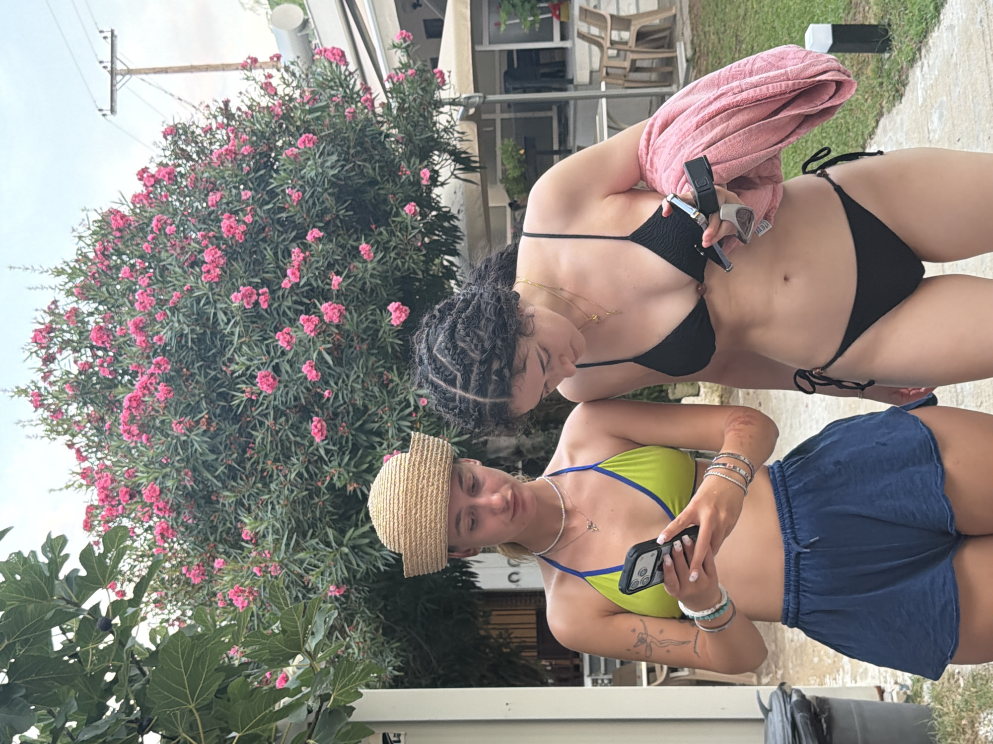 Lazy summer afternoon in Stavros — people, pink blooms, and a cat
