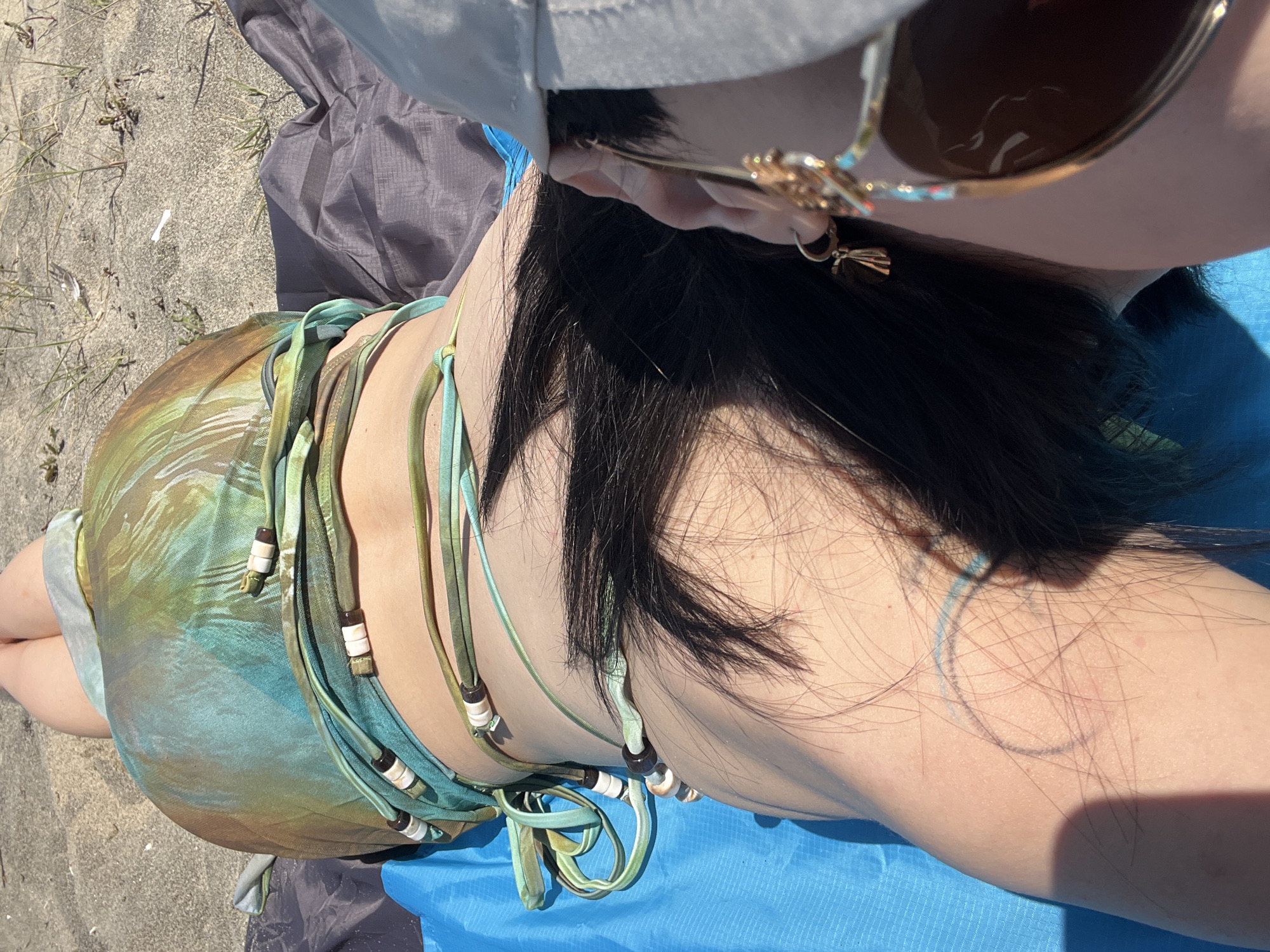 Woman sunbathes on Obzor Beach, Bulgaria during morning hours