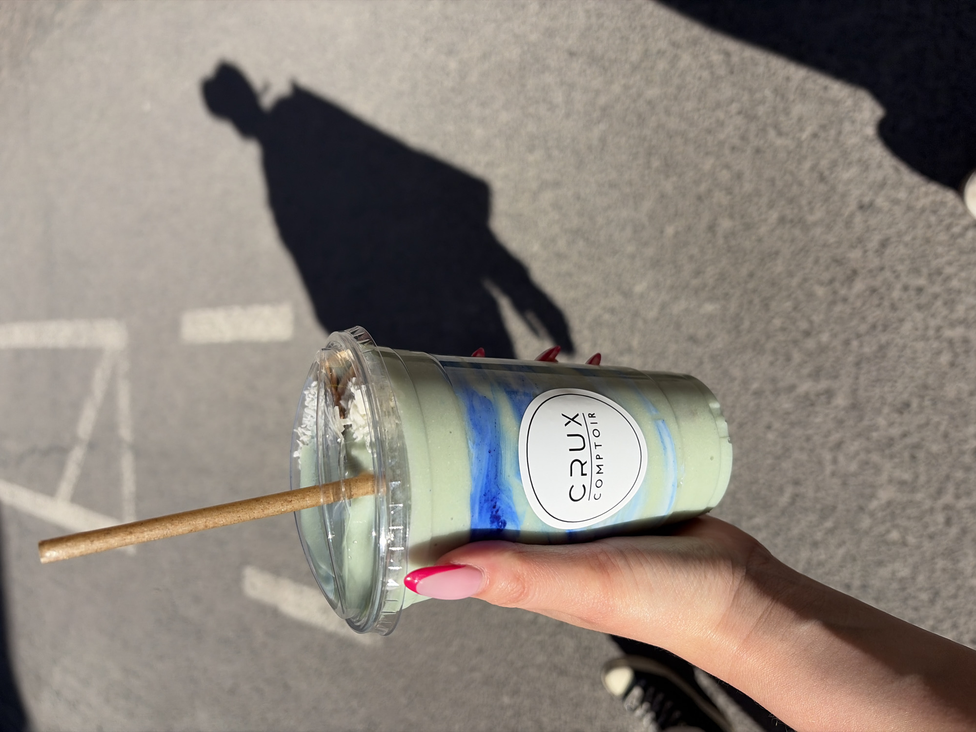Montreal resident enjoys colorful beverage from Crux Comptoir