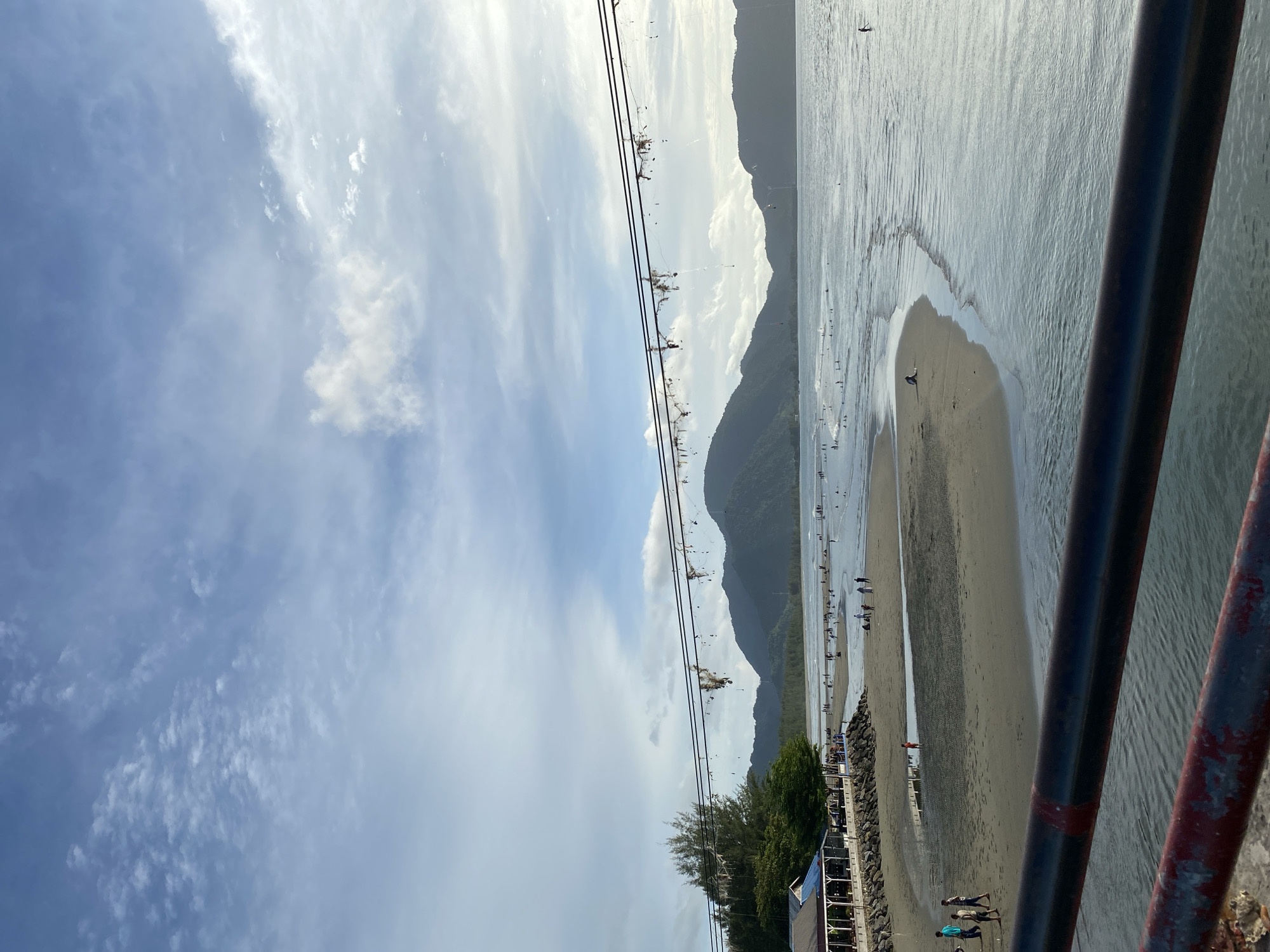 Banda Aceh waterfront: coastal promenade, bridge traffic, and boats